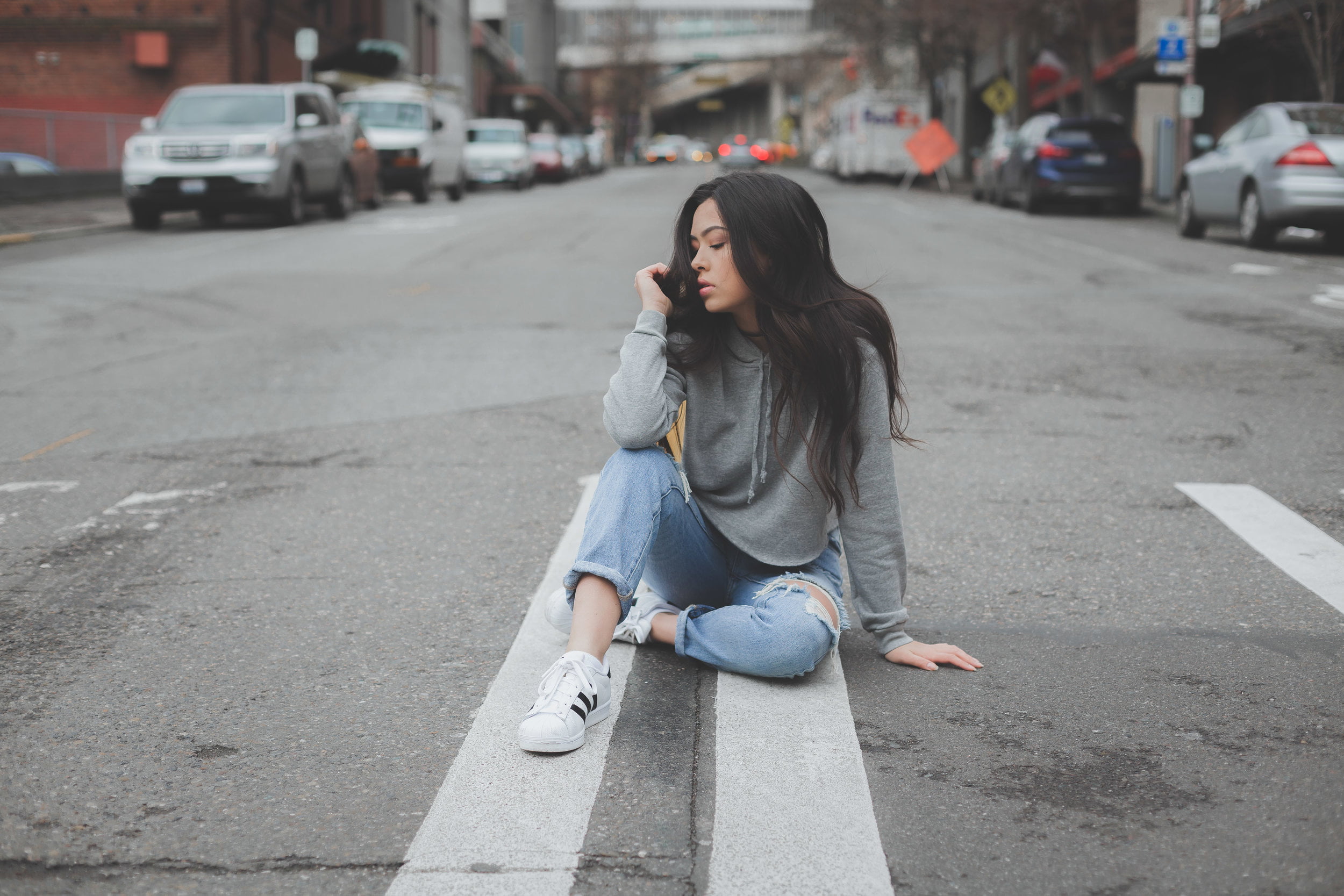 hair, touching hair, city, on the floor, young adult, sitting, road, casual clothing, lifestyles, jeans, full length, beautiful woman, women, long hair, HD Wallpaper