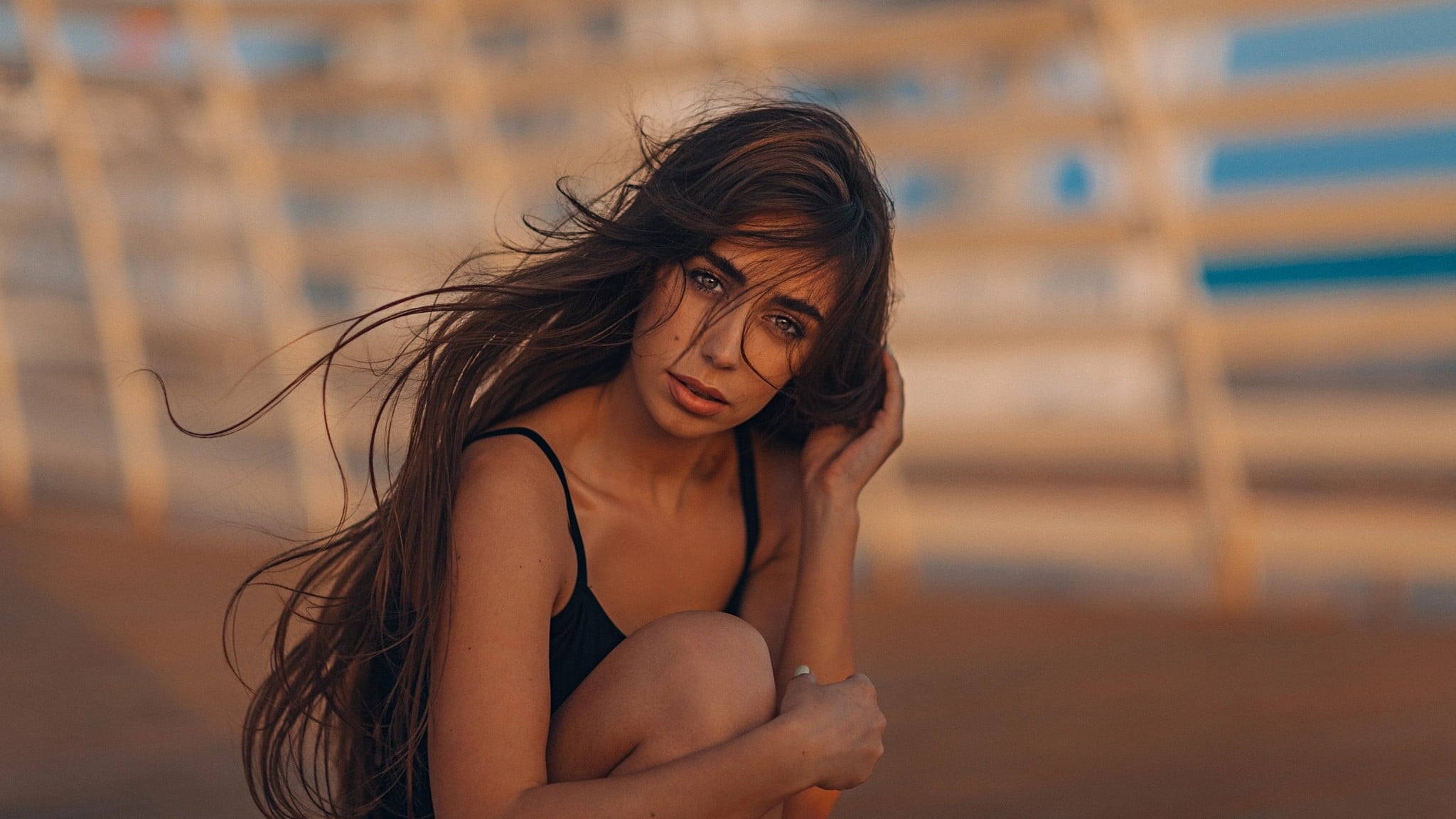 women outdoors, windy, hair in face, bare shoulders, long hair, Grigoriy Lifin, face, tank top, bokeh, brunette, depth of field, looking at viewer, portrait, HD Wallpaper