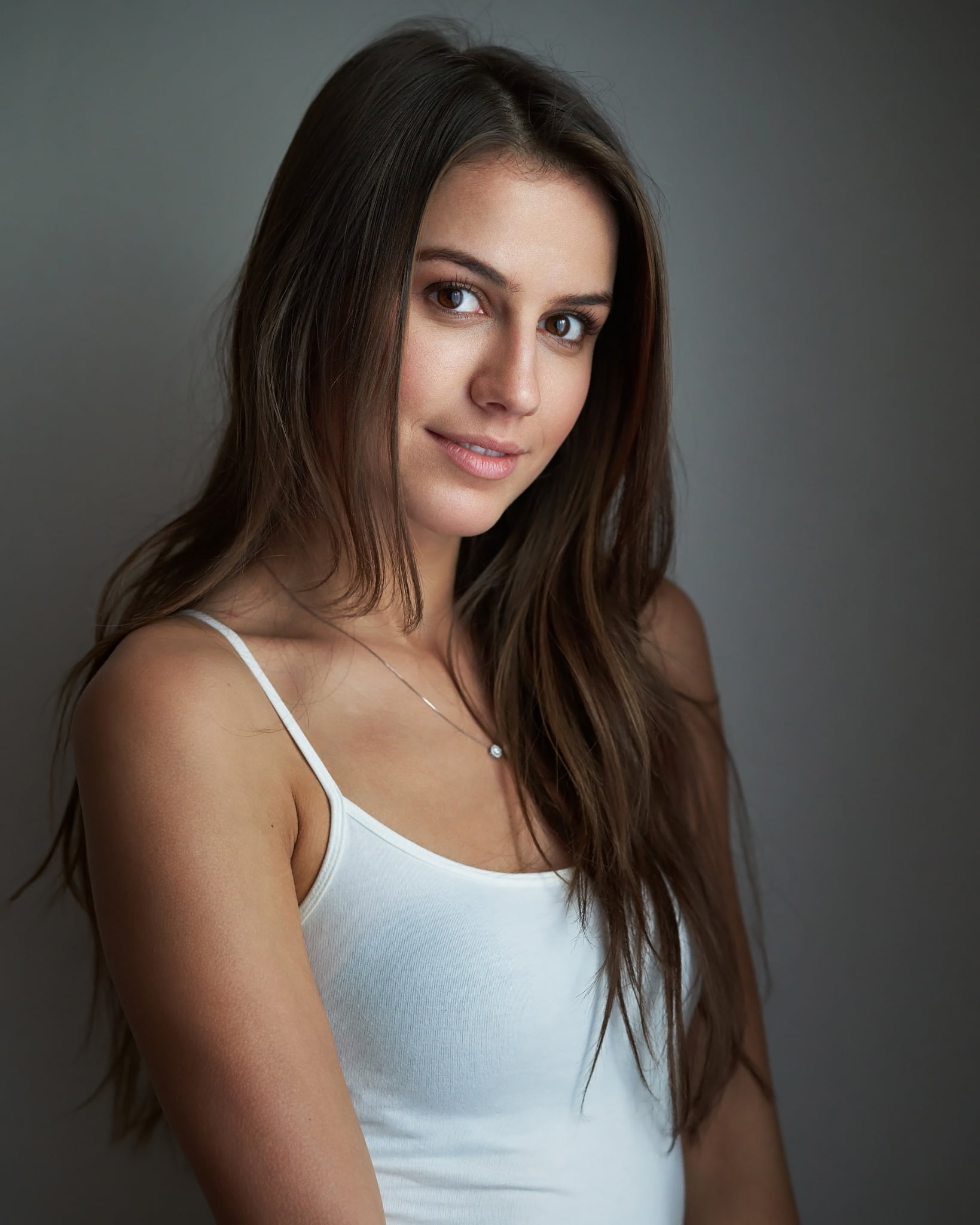 smiling, portrait, 1080P, tank top, Milan R, jewelry, white clothing, brown eyes, brunette, straight hair, long hair, simple background, looking at viewer, Phone HD Wallpaper