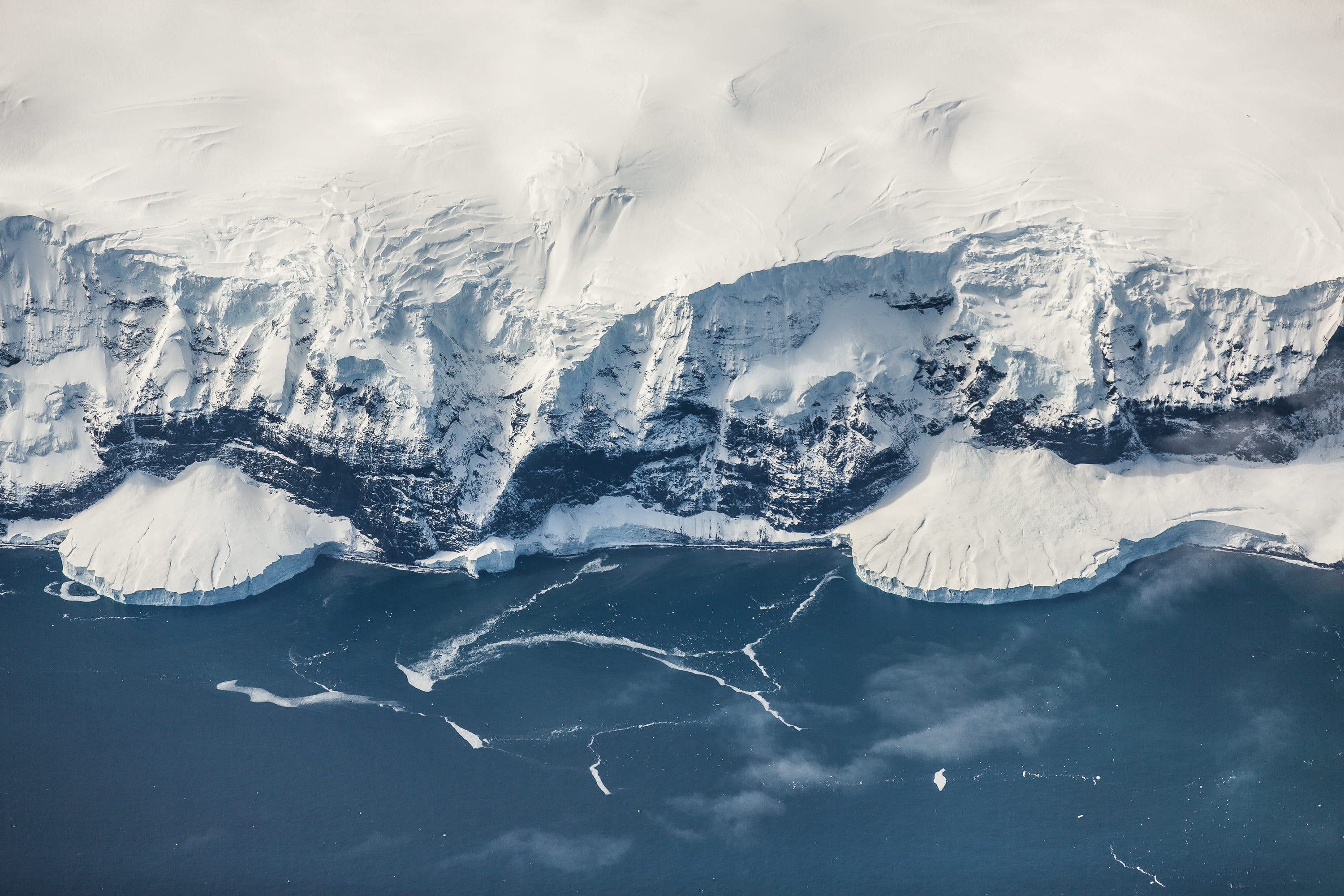 2K, covered, cliff, ocean, frontier, tranquil scene, coastline, aerial view, land, view, environment, water, power in nature, non-urban scene, cold, cold temperature, HD Wallpaper