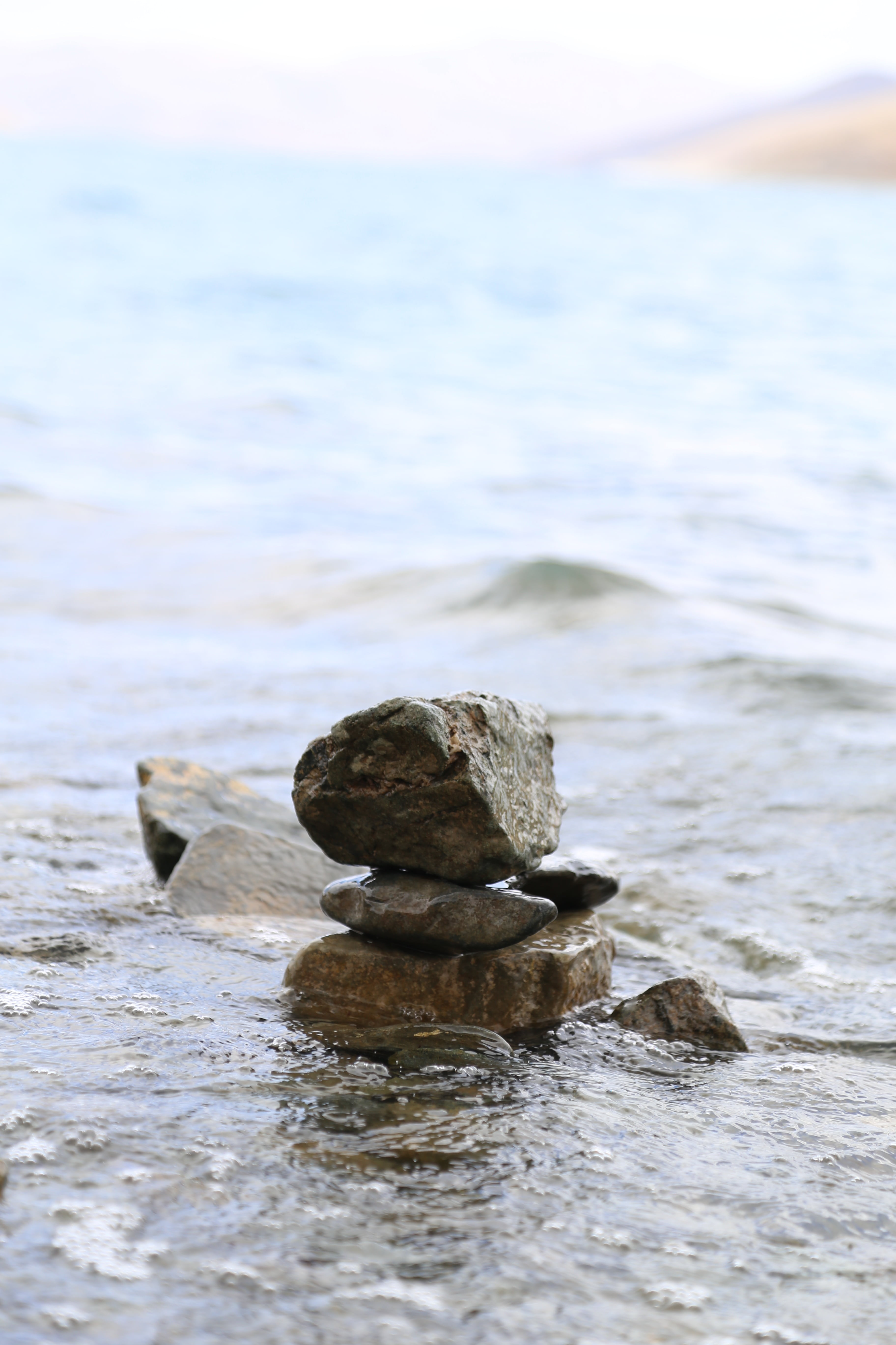 water, mani dui, focus on foreground, no people, land, stone - object, day, selective focus, outdoors, sea, stack, mountain, blue, rock, beauty in nature, Phone HD Wallpaper