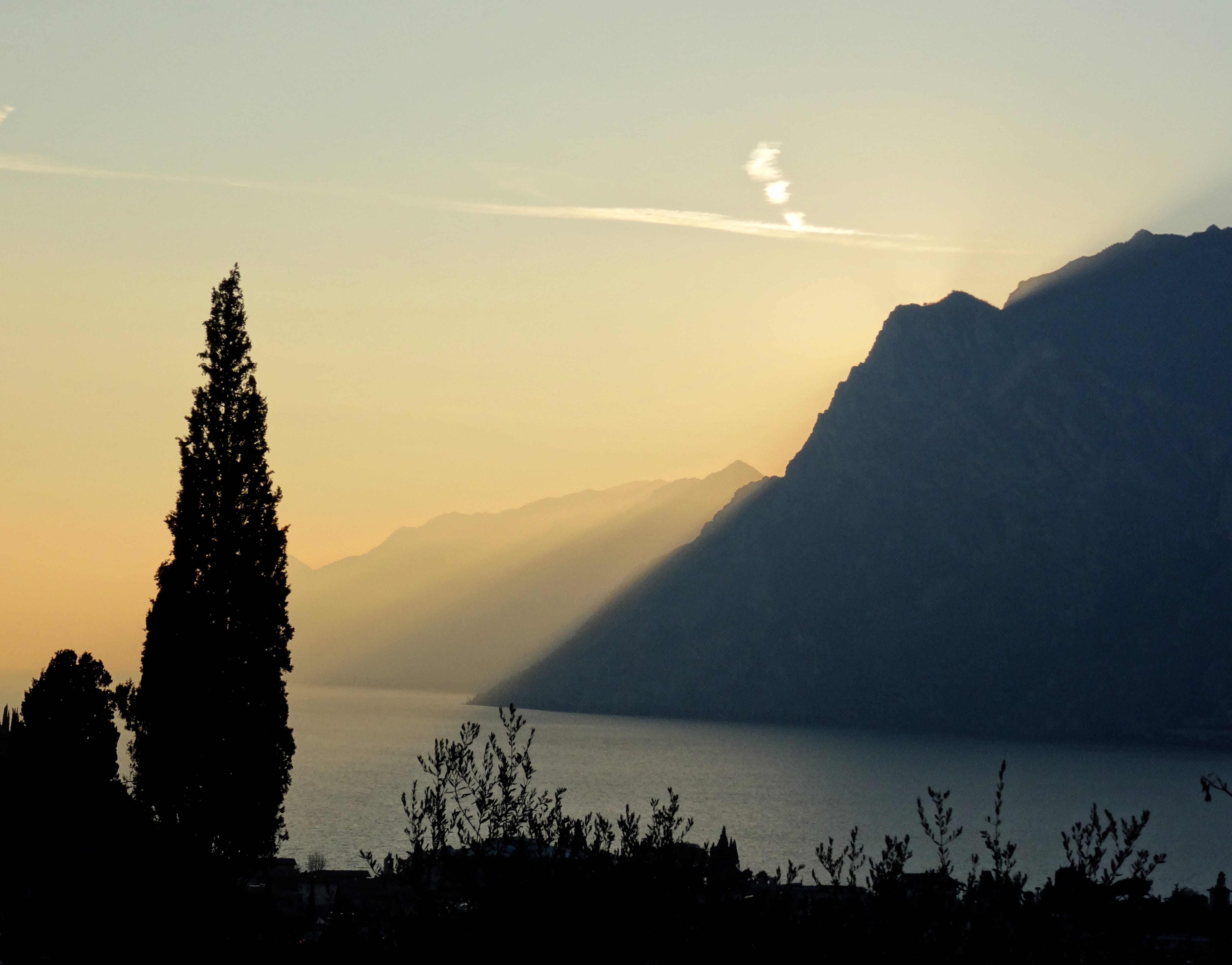 lake garda, nature, lake, plant, non-urban scene, no people, tree, gardasee, italy, sky, 4K, mountain, sunbeam, sunset, water, mountain range, outdoors, HD Wallpaper