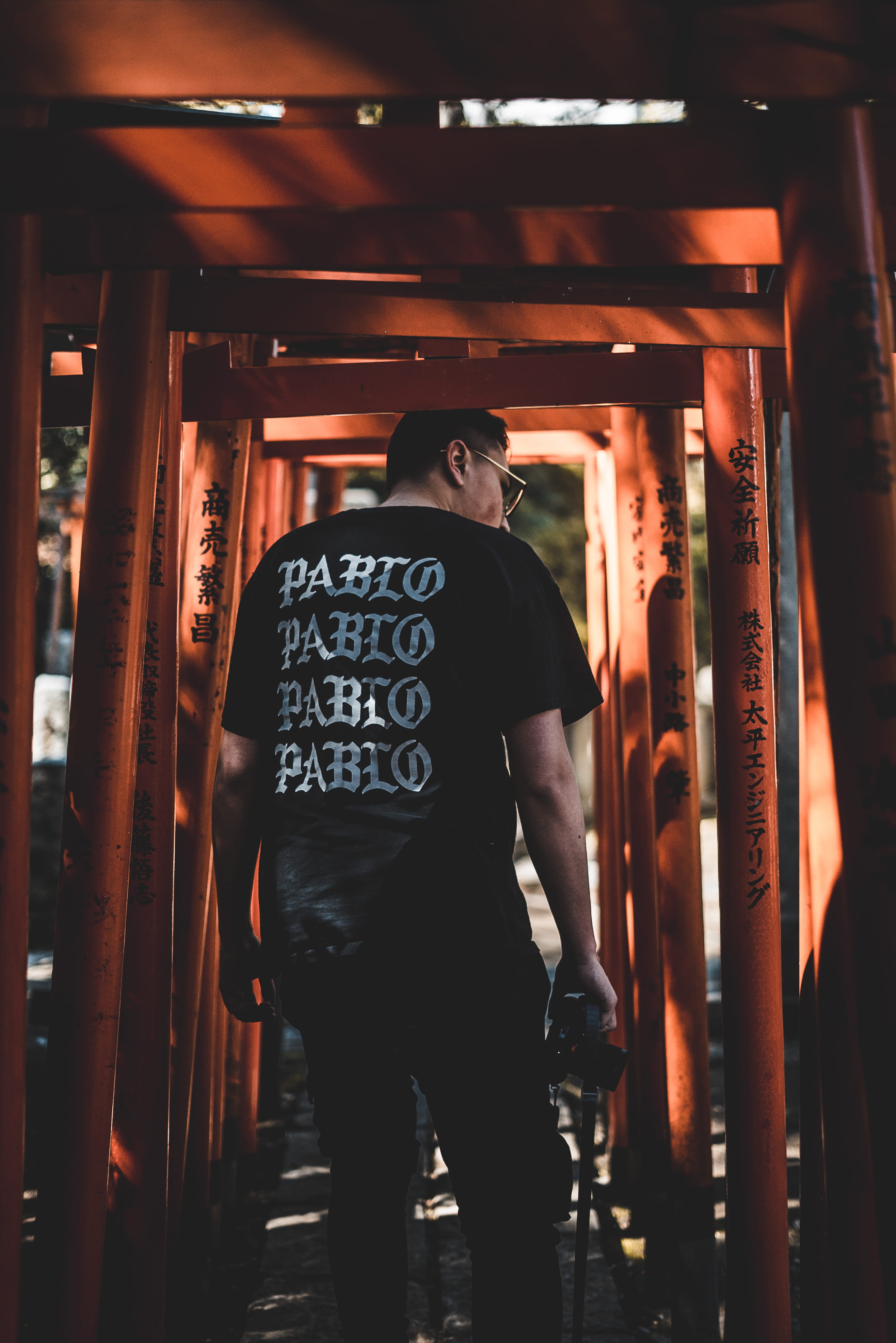 portrait, urban, built structure, street, full length, building, text, tshirt, place of worship, real people, orange, man, camera, back, illuminated, shooter, Phone HD Wallpaper