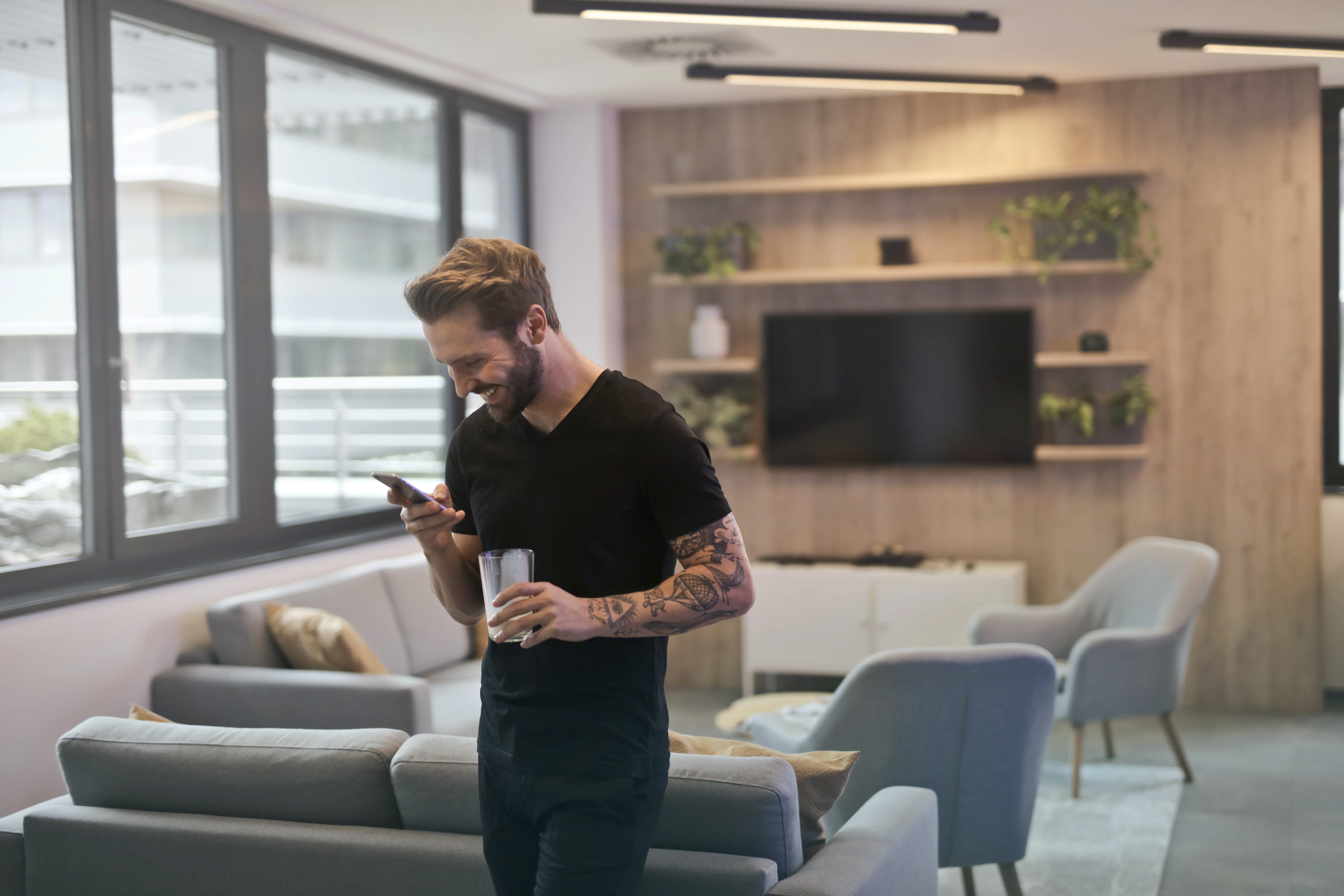 drinking glass, wireless, window, living room, phone, desk, males, furnitures, standing, chairs, furniture, electronics, mobile, looking down, business, HD Wallpaper