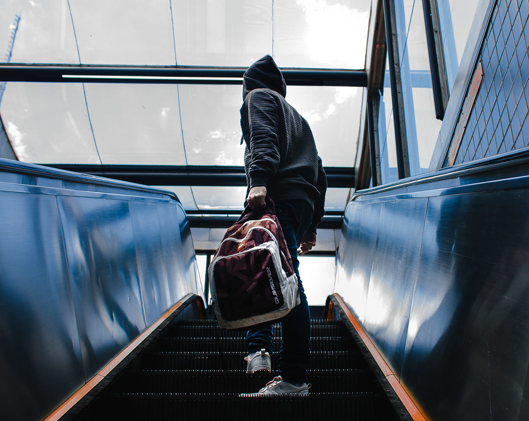 grey sky, train, one person, casual clothing, moving walkway, outdoors, escalator, hooded, mode of transportation, wearing, motion, hoody sweater, upstairs, HD Wallpaper