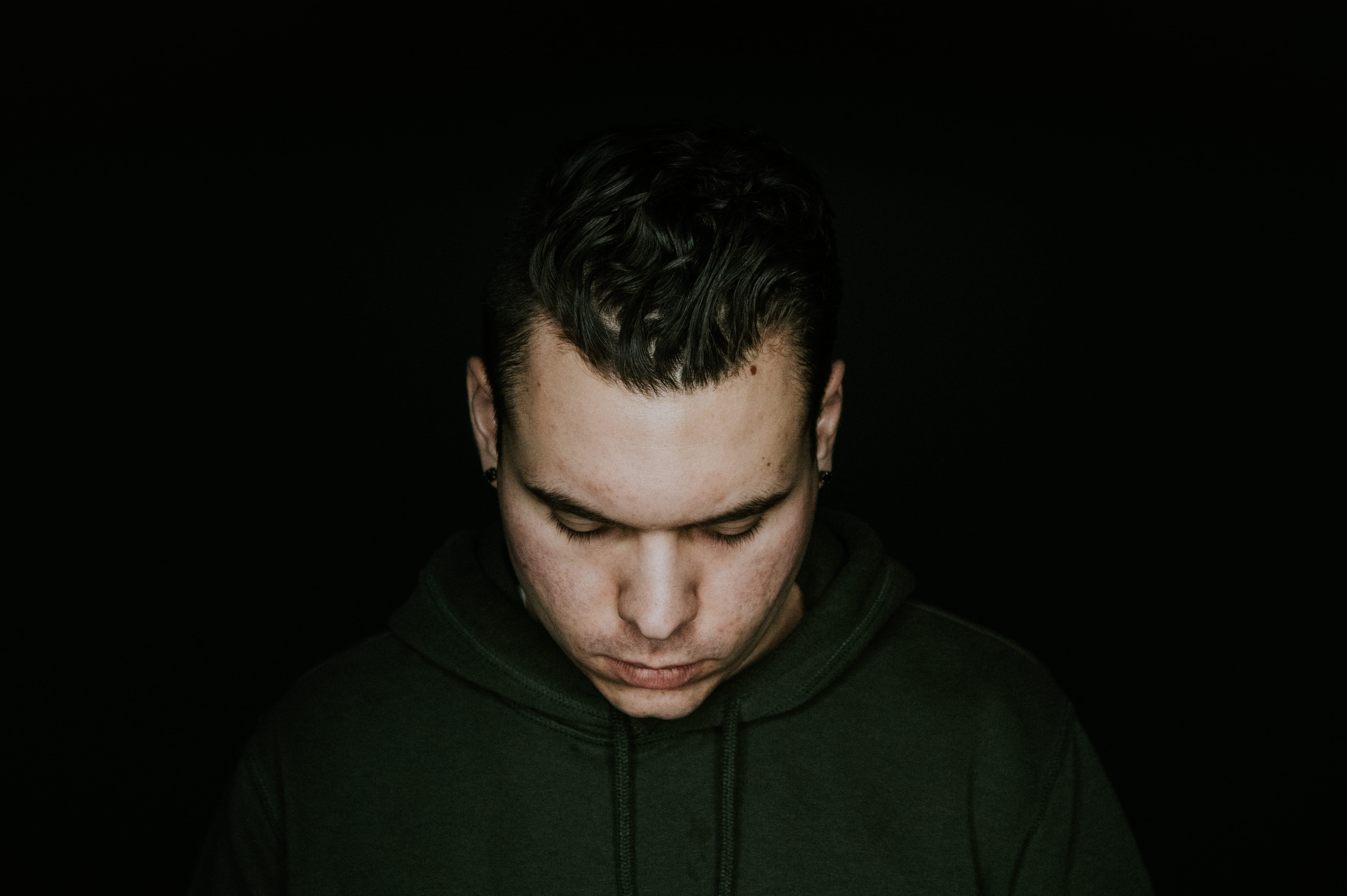 sadness, looking down, face, one person, 5K, depression - sadness, indoors, black, background, person, black background, adult, photography, contemplation, HD Wallpaper