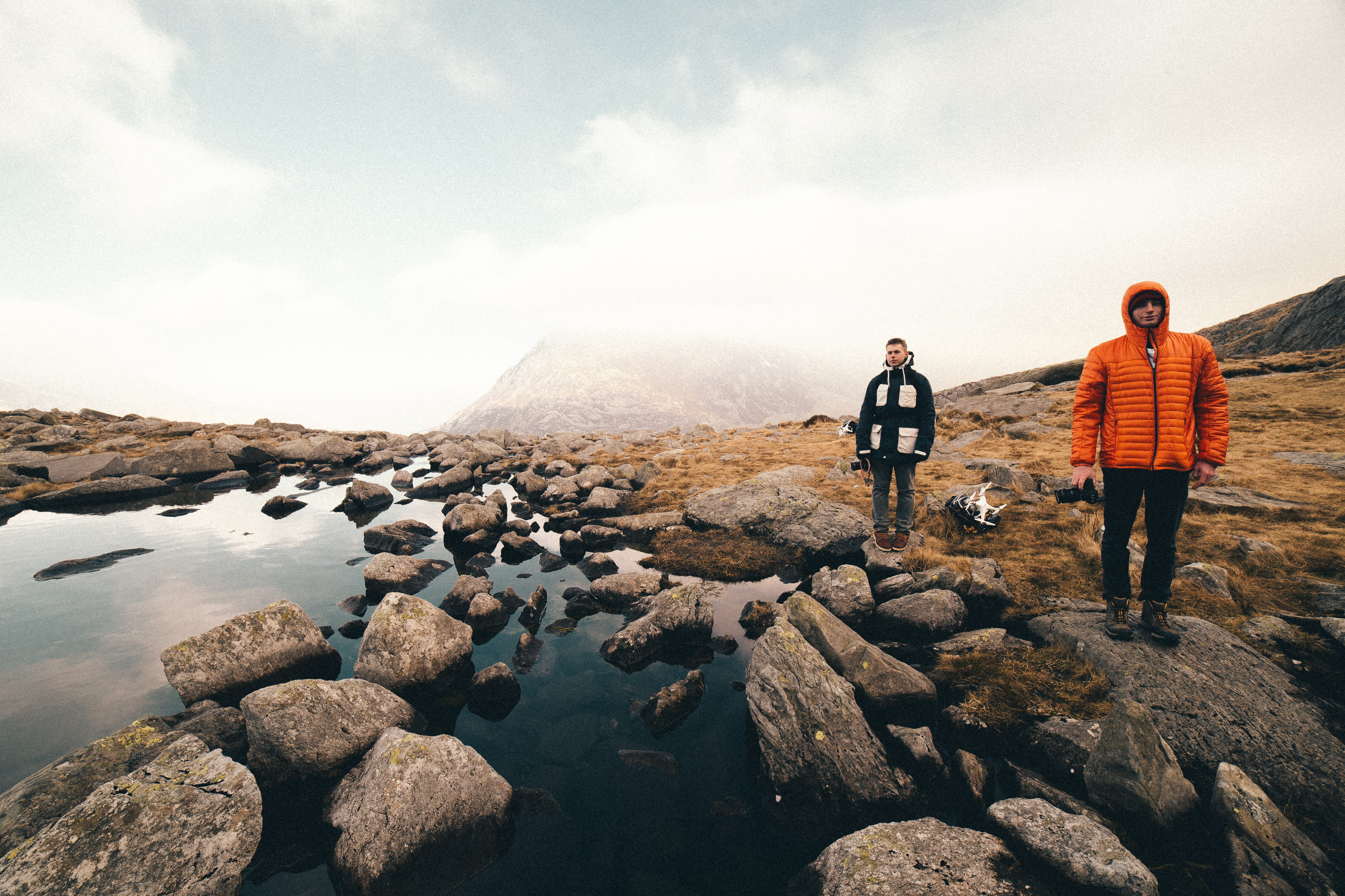 solid, rock - object, body, scenics, recreational Pursuit, white sky, nature, copy Space, caucasian Ethnicity, hoodies, wearing, men in black, jacket, black and orange, HD Wallpaper