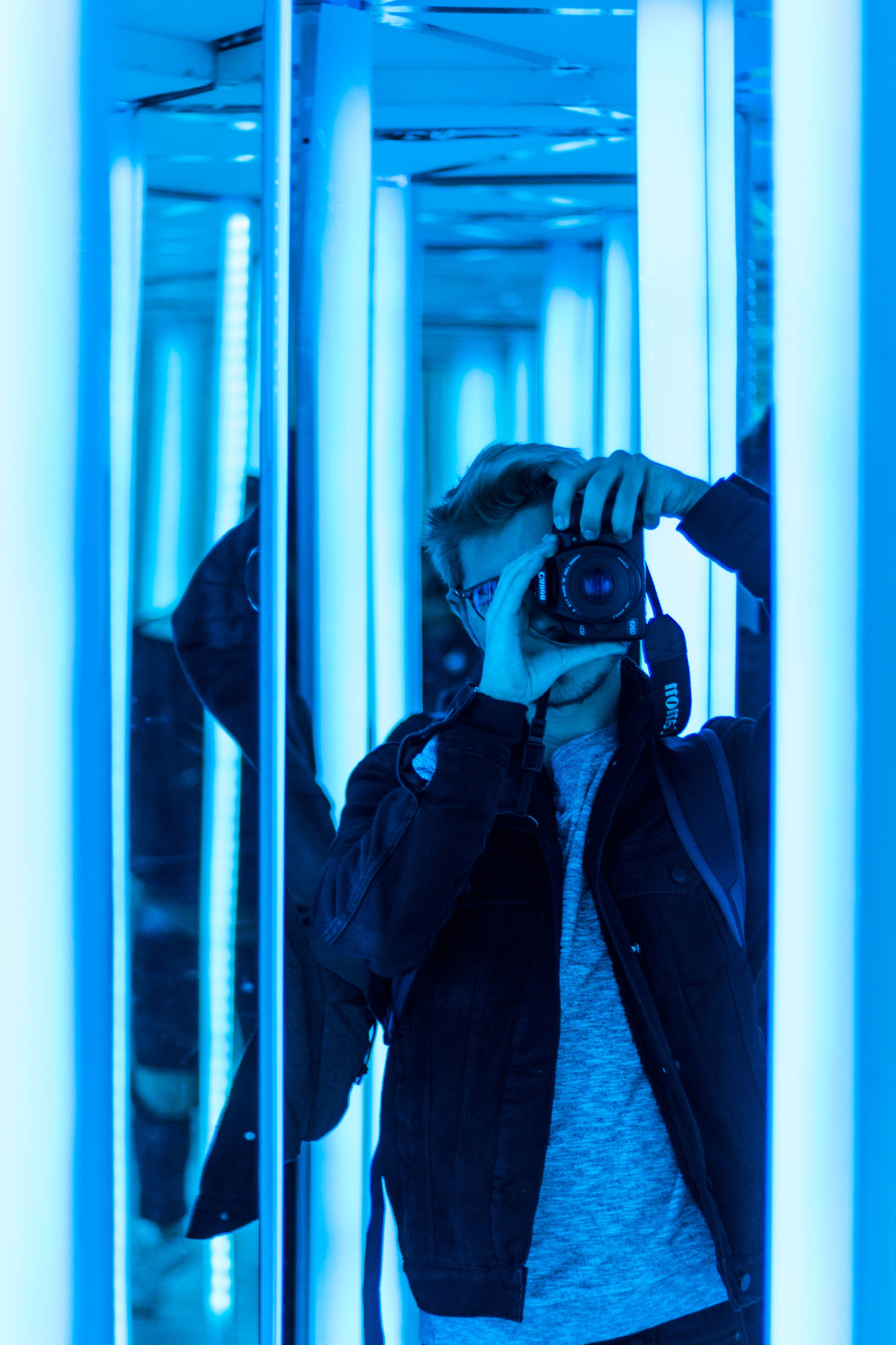 window, lifestyles, front, real people, technology, clothing, leisure activity, arms raised, casual clothing, taking, human arm, neon, boy, using, standing, Phone HD Wallpaper