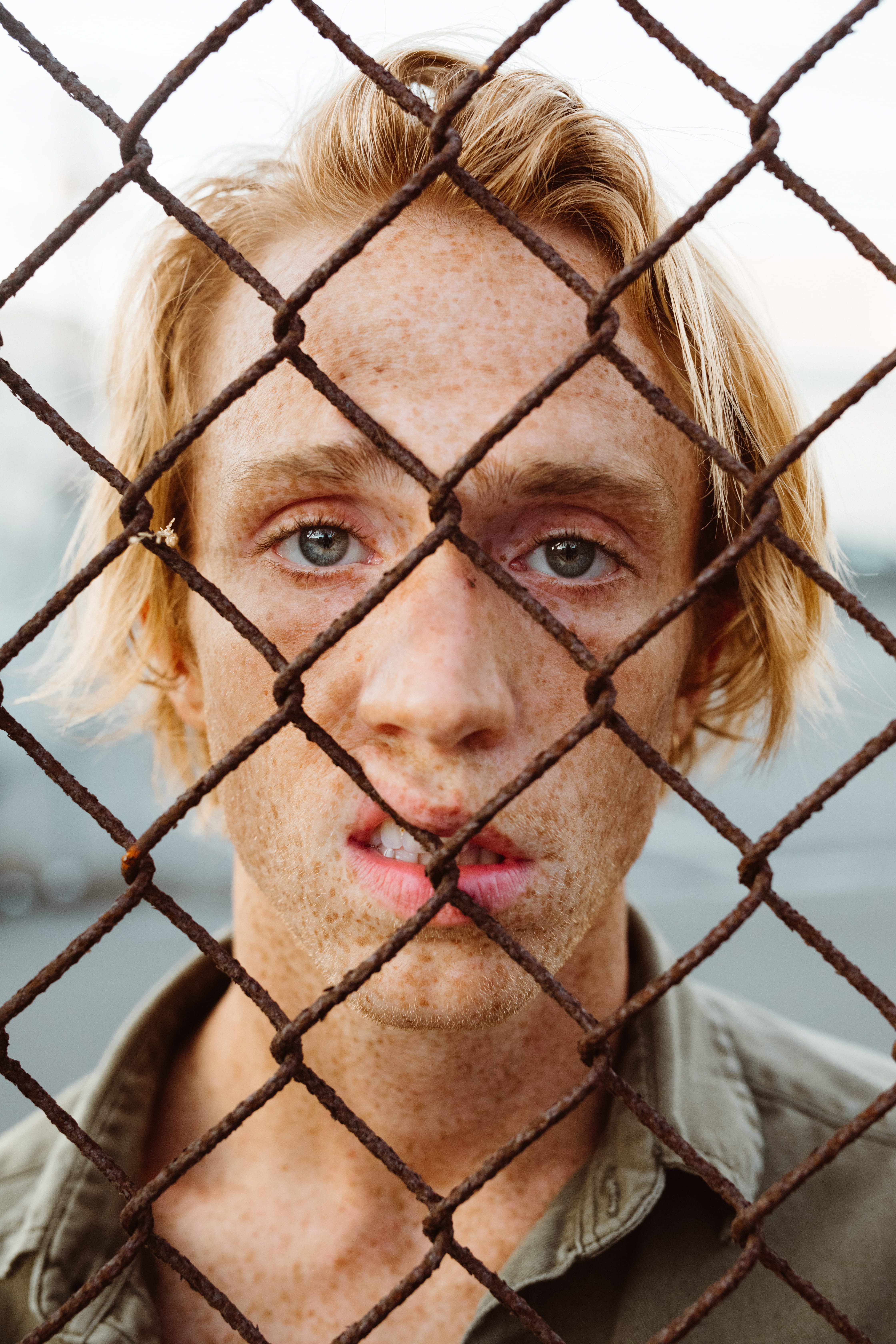 headshot, person, safety, close-up, standing, security, freckle, animal, 5K, young adult, fence, shirt, protection, face, one person, mouth, focus on foreground, Phone HD Wallpaper