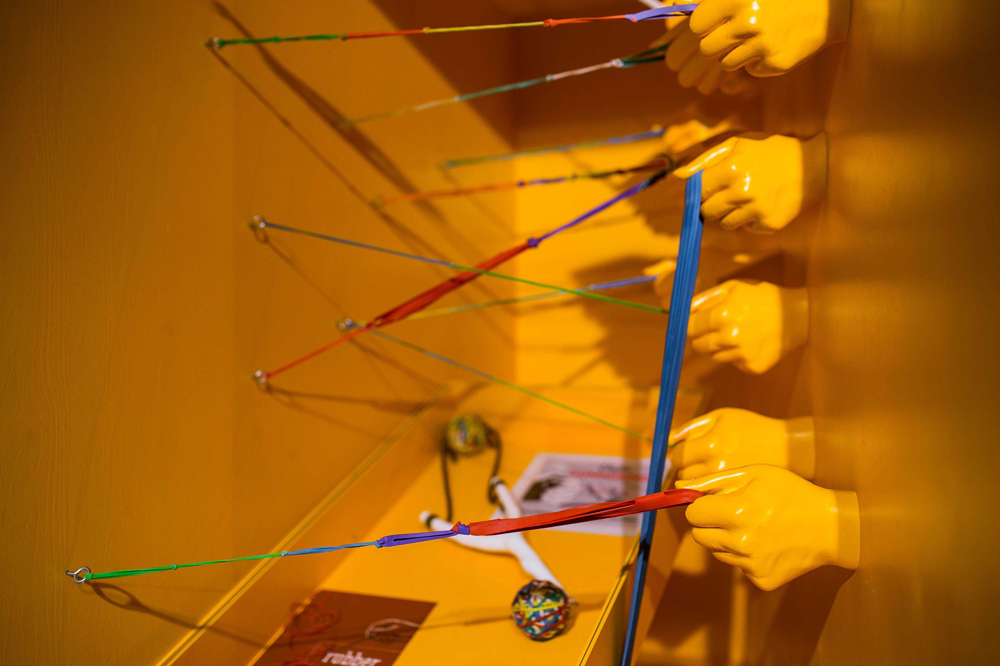 human hand, holding, art, exhibition, indoors, 4K, rubber, hands, selective focus, wall - building feature, occupation, yellow, plastic, bands, working, HD Wallpaper
