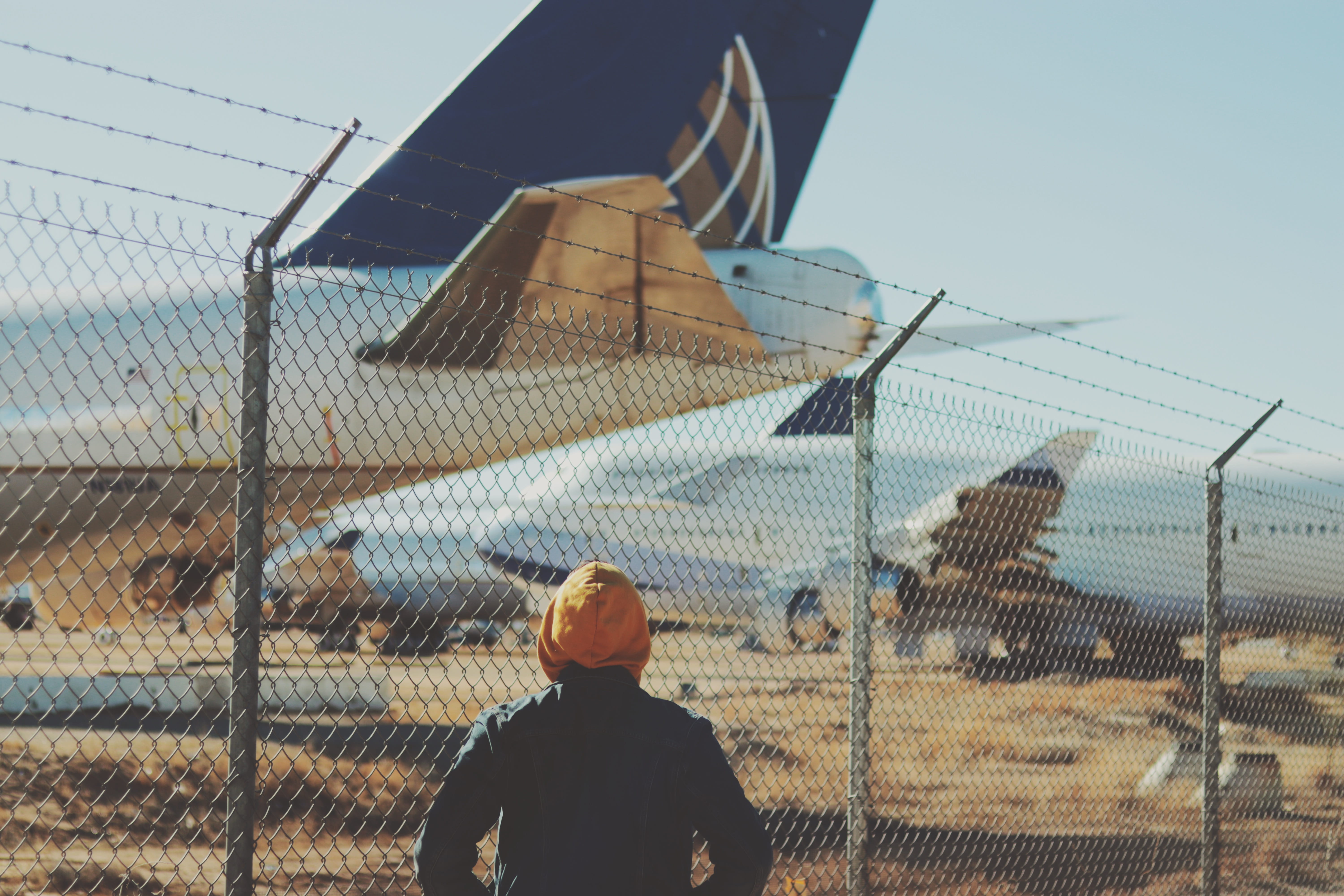 cyclone fence, barrier, aviation, 5K, person, men, urban, lifestyles, fence, steel, chain, rear view, aircraft, real people, technology, metal, barbed wire, HD Wallpaper
