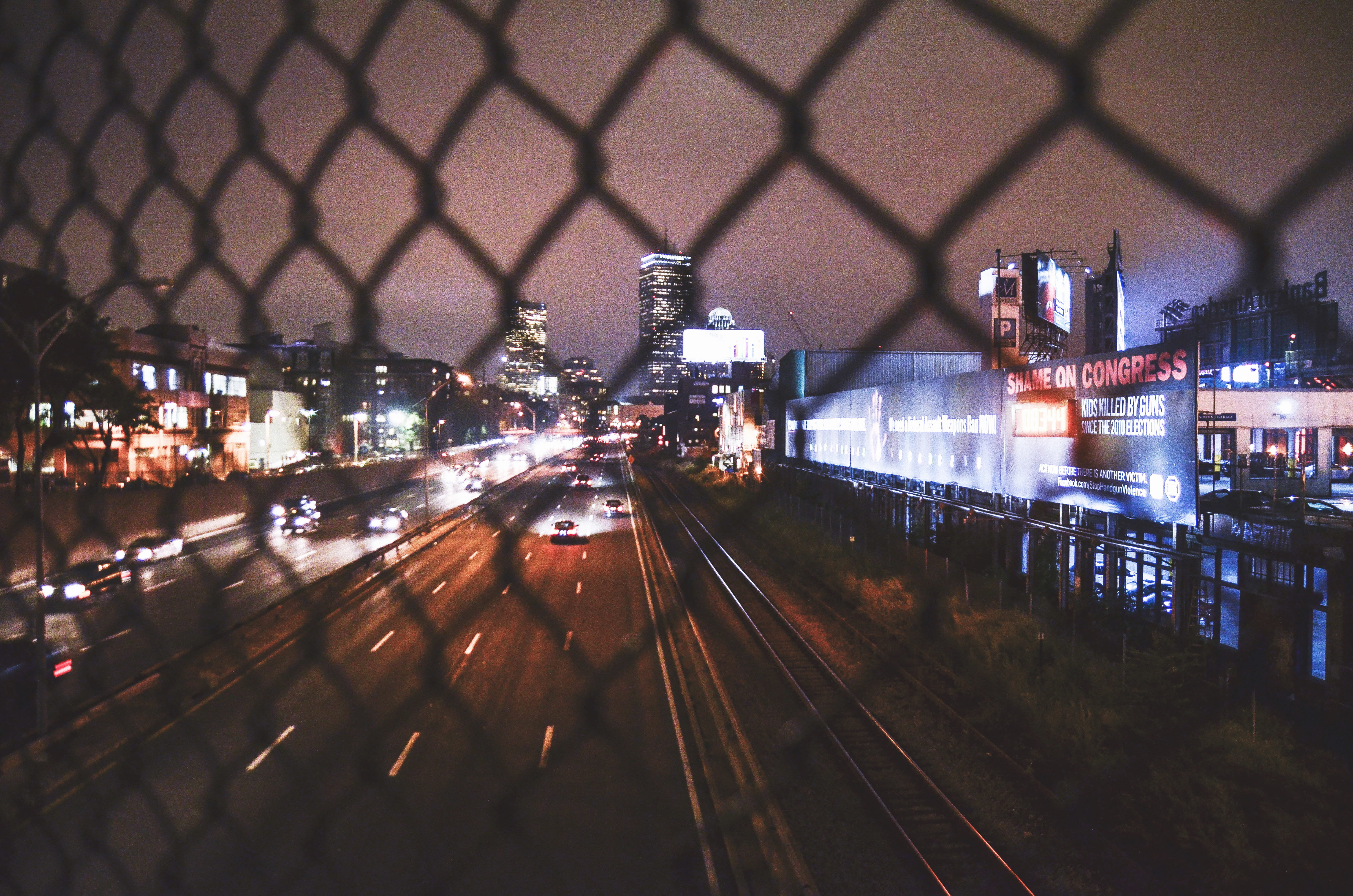 road, skyscraper, billboard, chain link view of underpass, train track, architecture, traffic, roadway, running, building exterior, no people, motion, public transportation, HD Wallpaper