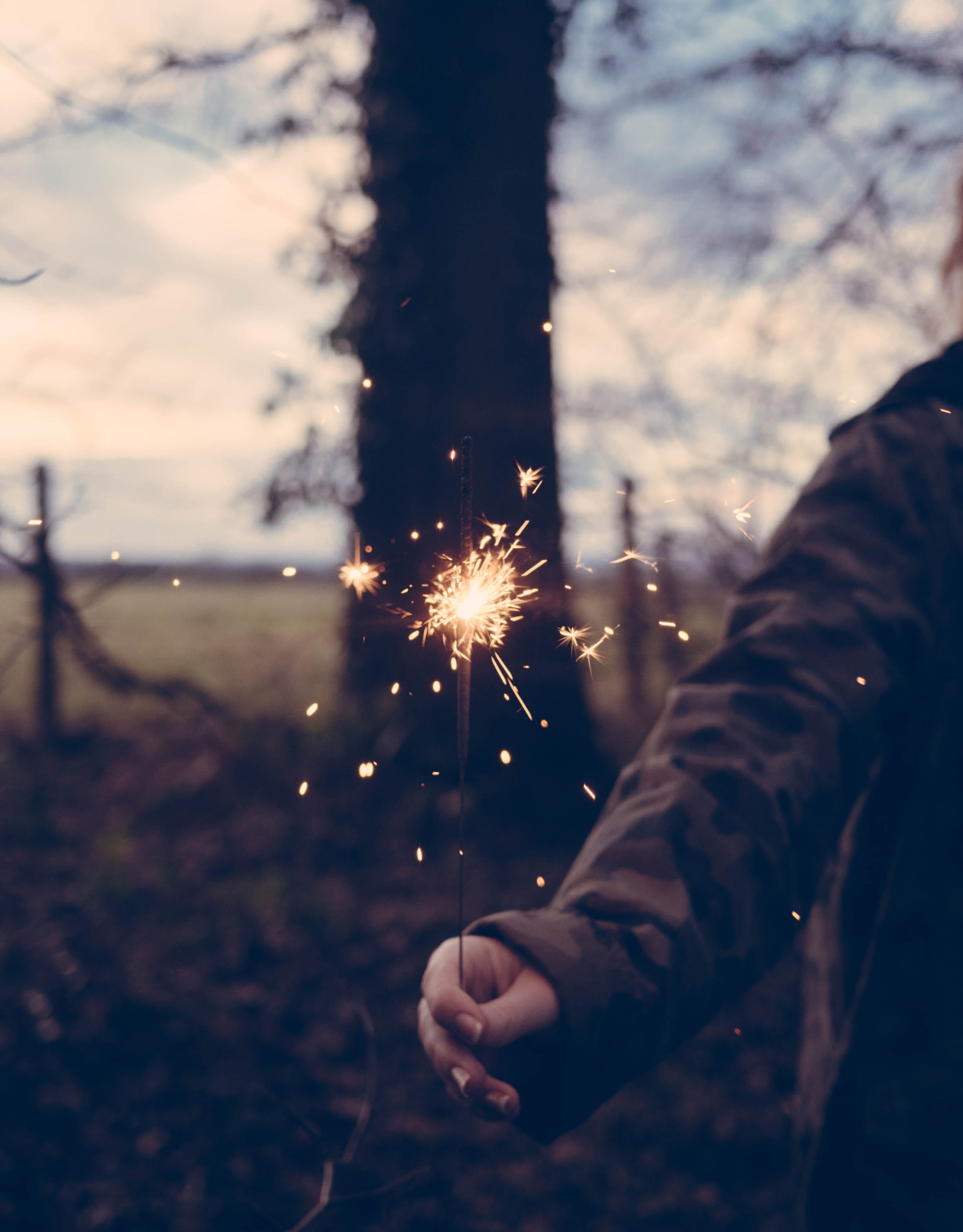 burning, outdoors, exploding, men, focus on foreground, blurred motion, person, heat - Temperature, spark, stick, human Hand, sparks, night, human body part, Phone HD Wallpaper