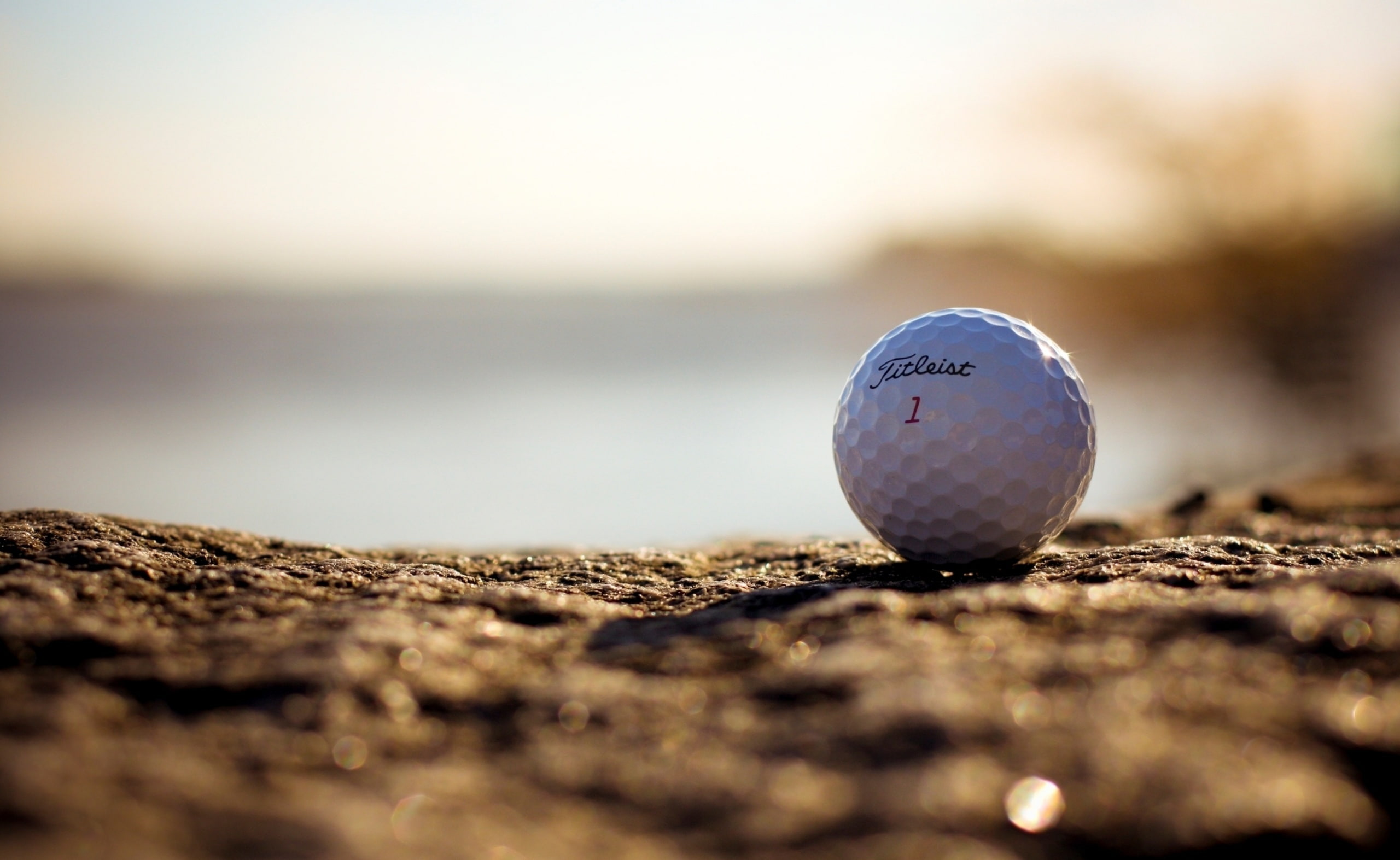 titleist, sphere, sport, sand, nature, surface level, Sports, golf ball, no people, 2K, close-up, sky, day, golf course, circle, single object, selective focus, HD Wallpaper