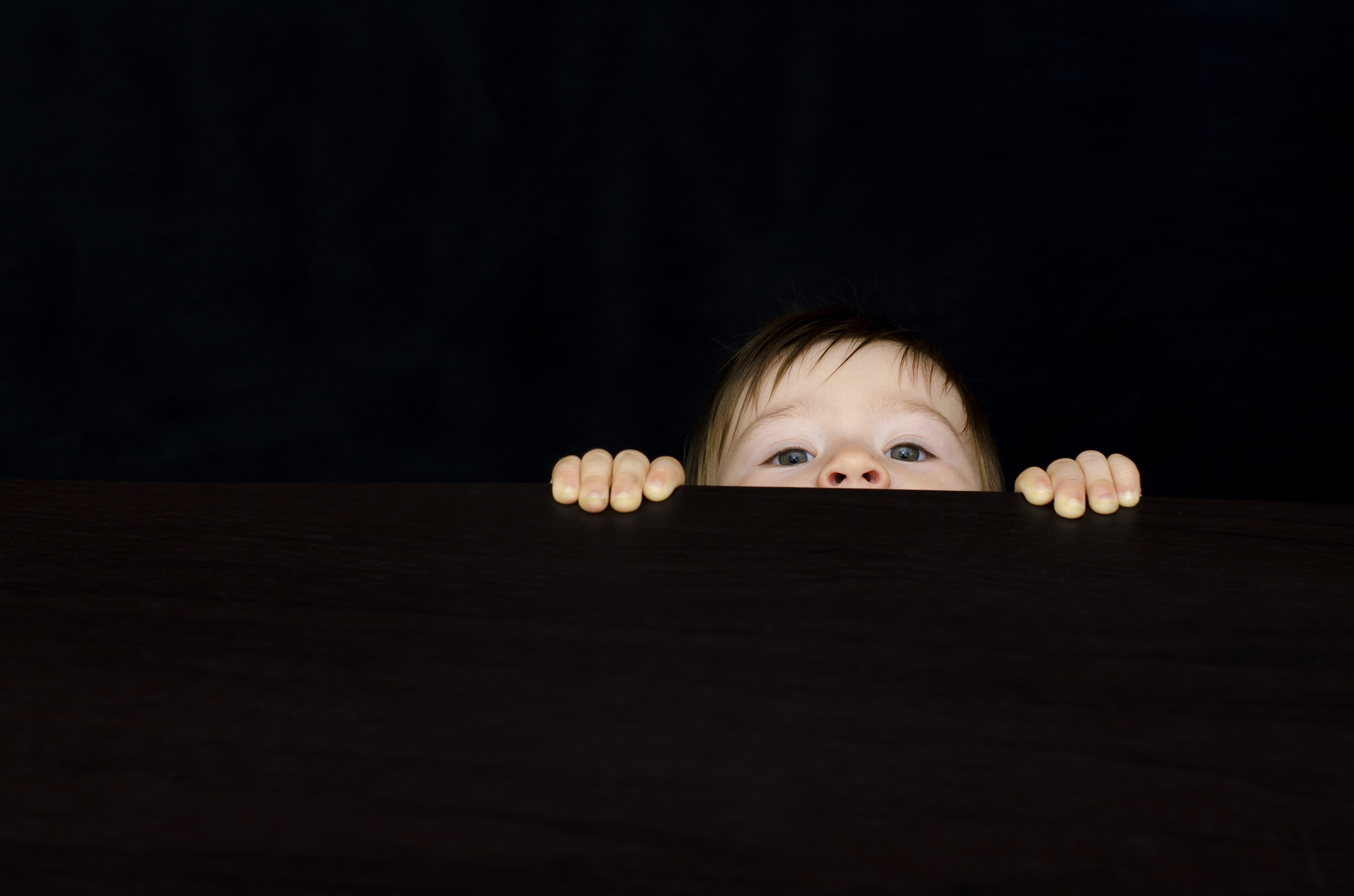 cute, human face, face, looking, desk, dark, child, one person, peeking, body part, boy, baby, copy space, black background, childhood, emotion, hands, HD Wallpaper