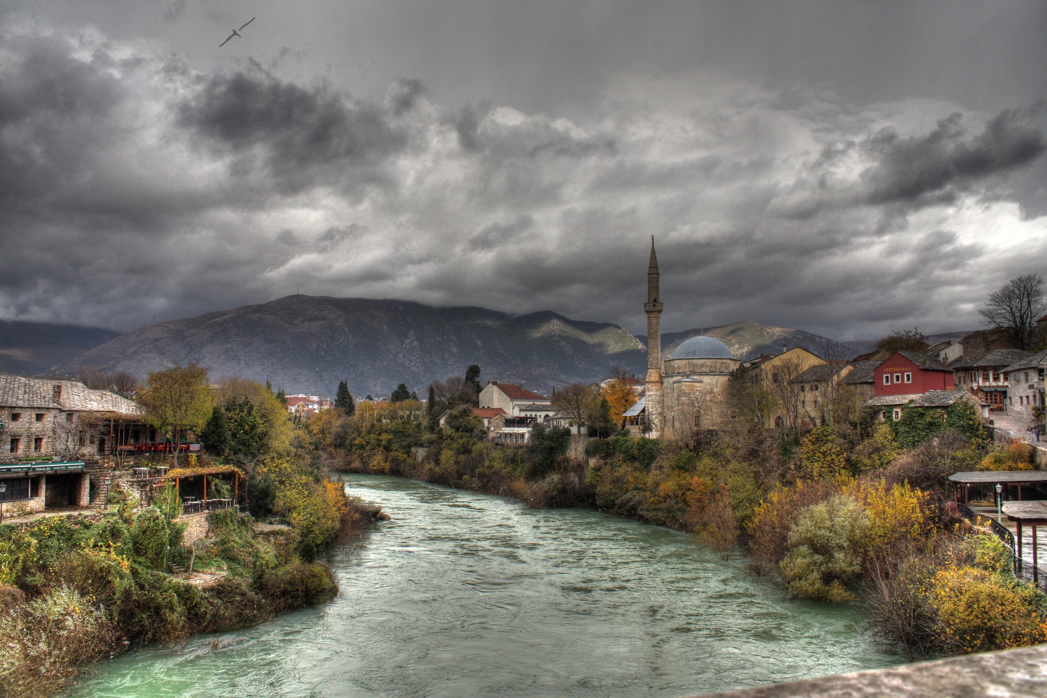storm, city, river, clouds, outdoors, building, residential district, tree, no people, architecture, mountain, house, storm cloud, water, nature, brown, HD Wallpaper