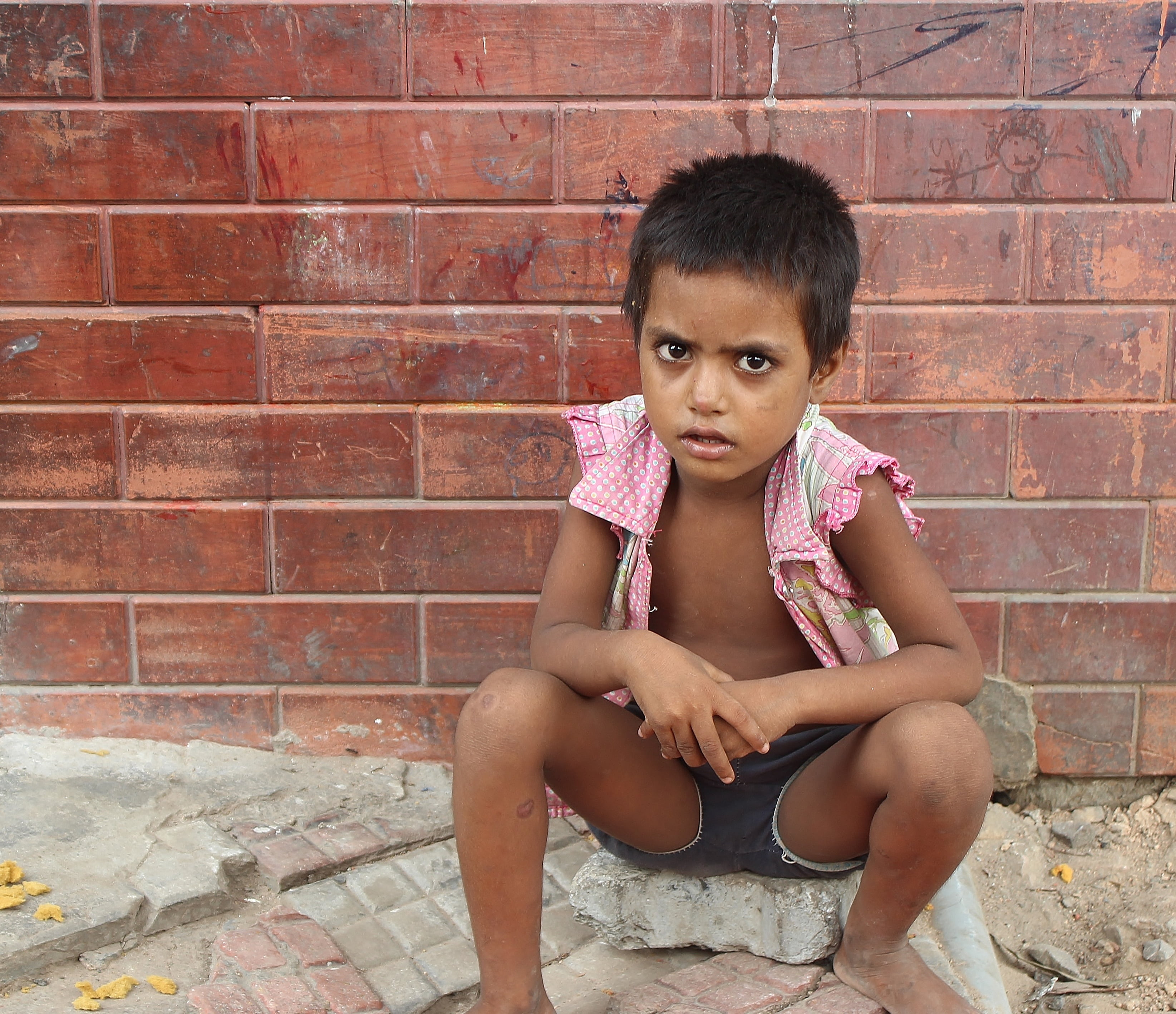 real people, asia, childhood, shorts, brick, front view, 2K, india, sitting, brick wall, day, new delhi, looking at camera, wall, architecture, depression - sadness, HD Wallpaper