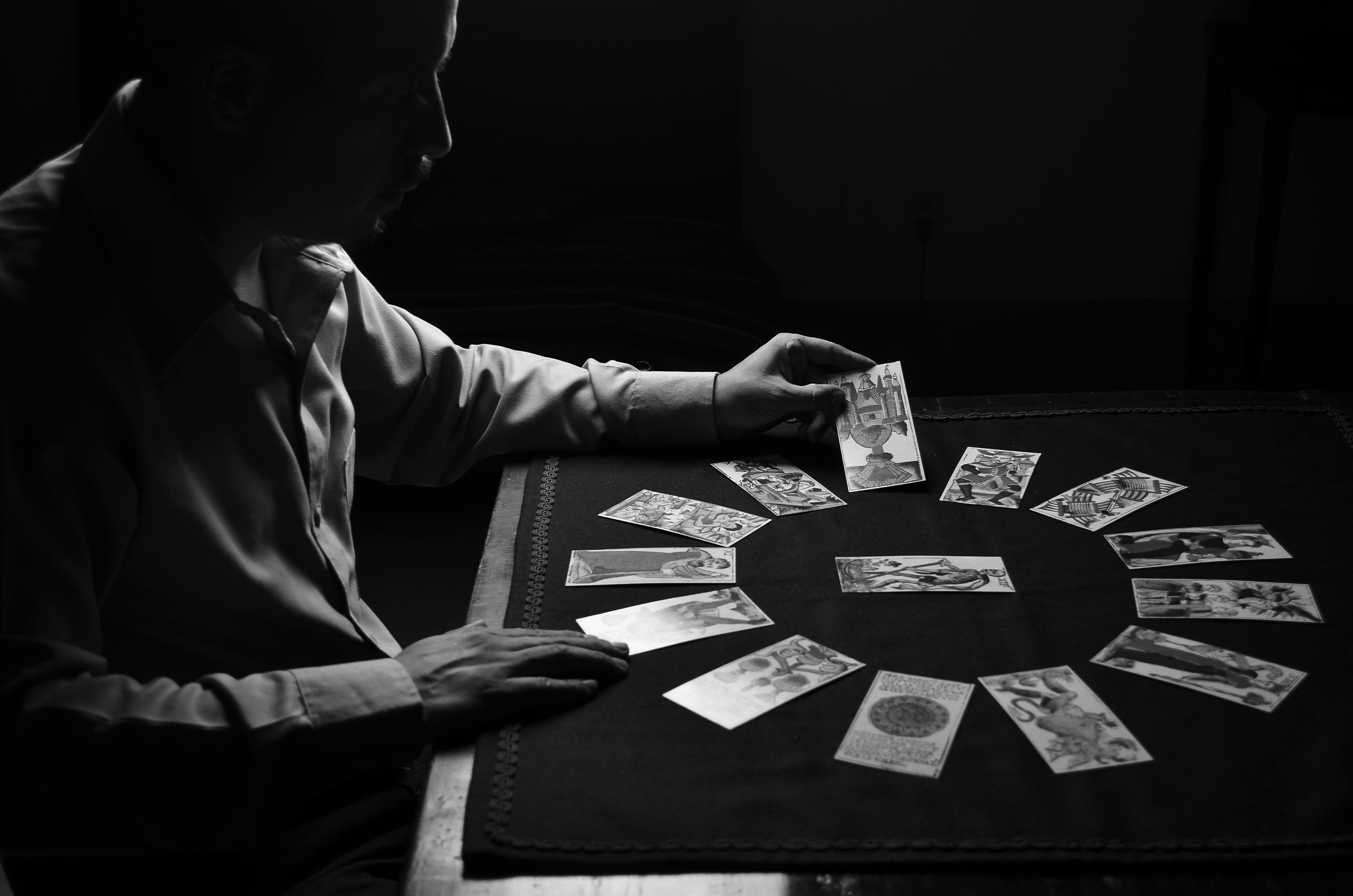 indoors, playing, person, cards, dark, 2K, game of chance, spiritualism, holding, tarot, front, men, luck, one person, relaxation, currency, opportunity, HD Wallpaper