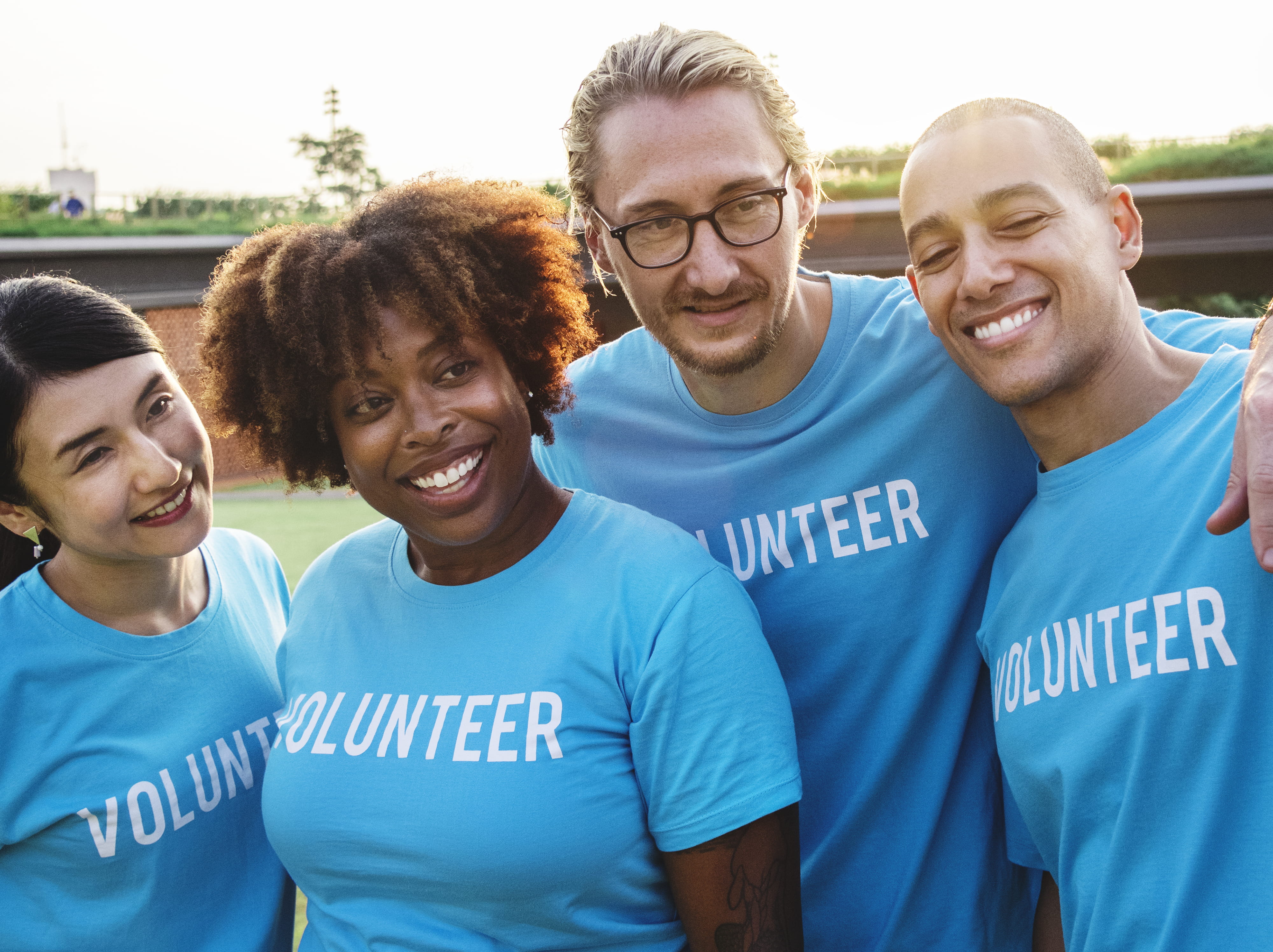 volunteering, men, kindness, group of people, standing, portrait, staff, lifestyles, charity and relief work, cheerful, eyewear, blue, adult, teeth, smile, HD Wallpaper