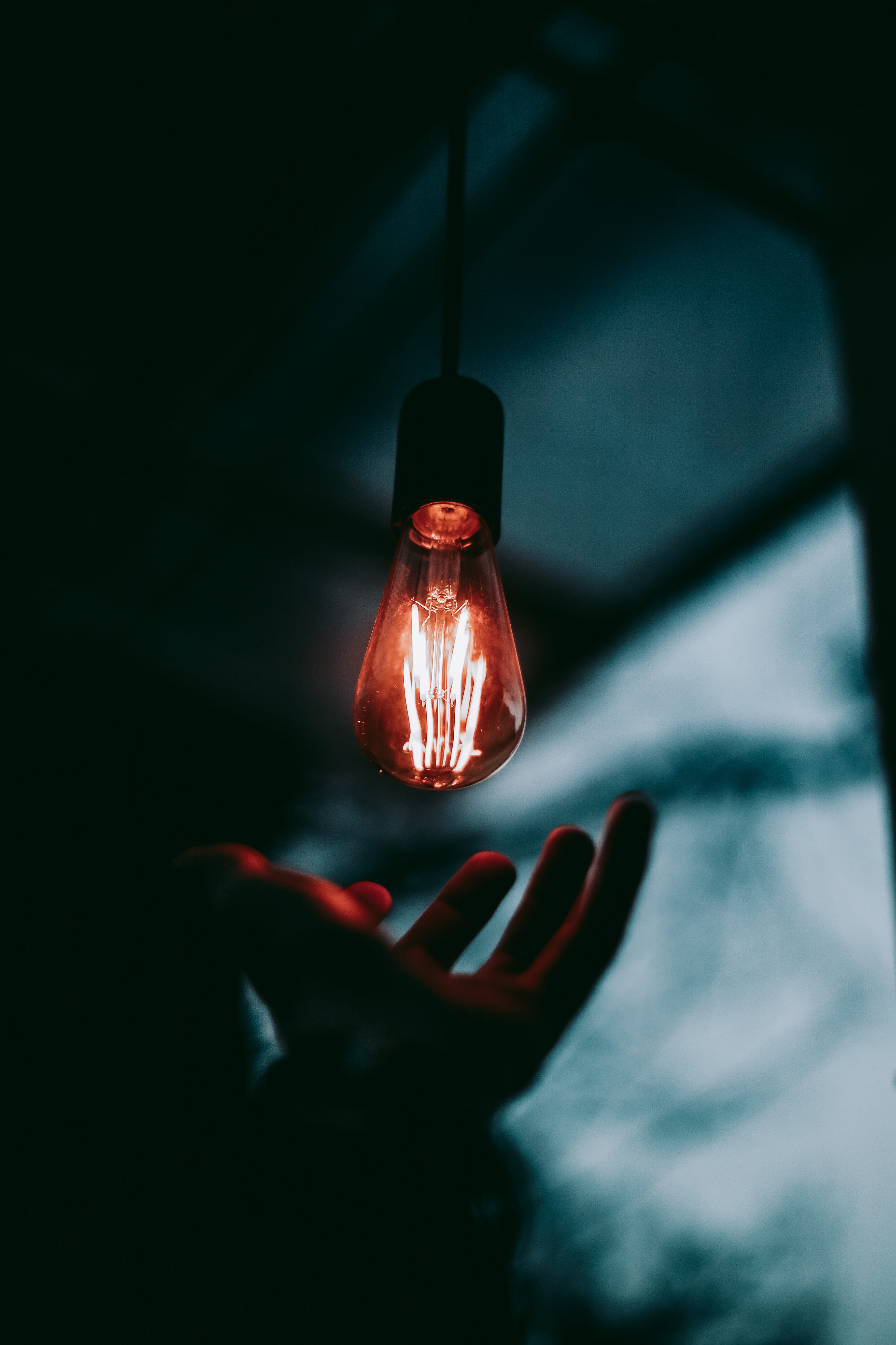 close-up, fullframe, lamp, reach, blue, real people, indoors, 5K, mood, electric light, focus on foreground, light bulb, dark, human hand, body part, human finger, Phone HD Wallpaper