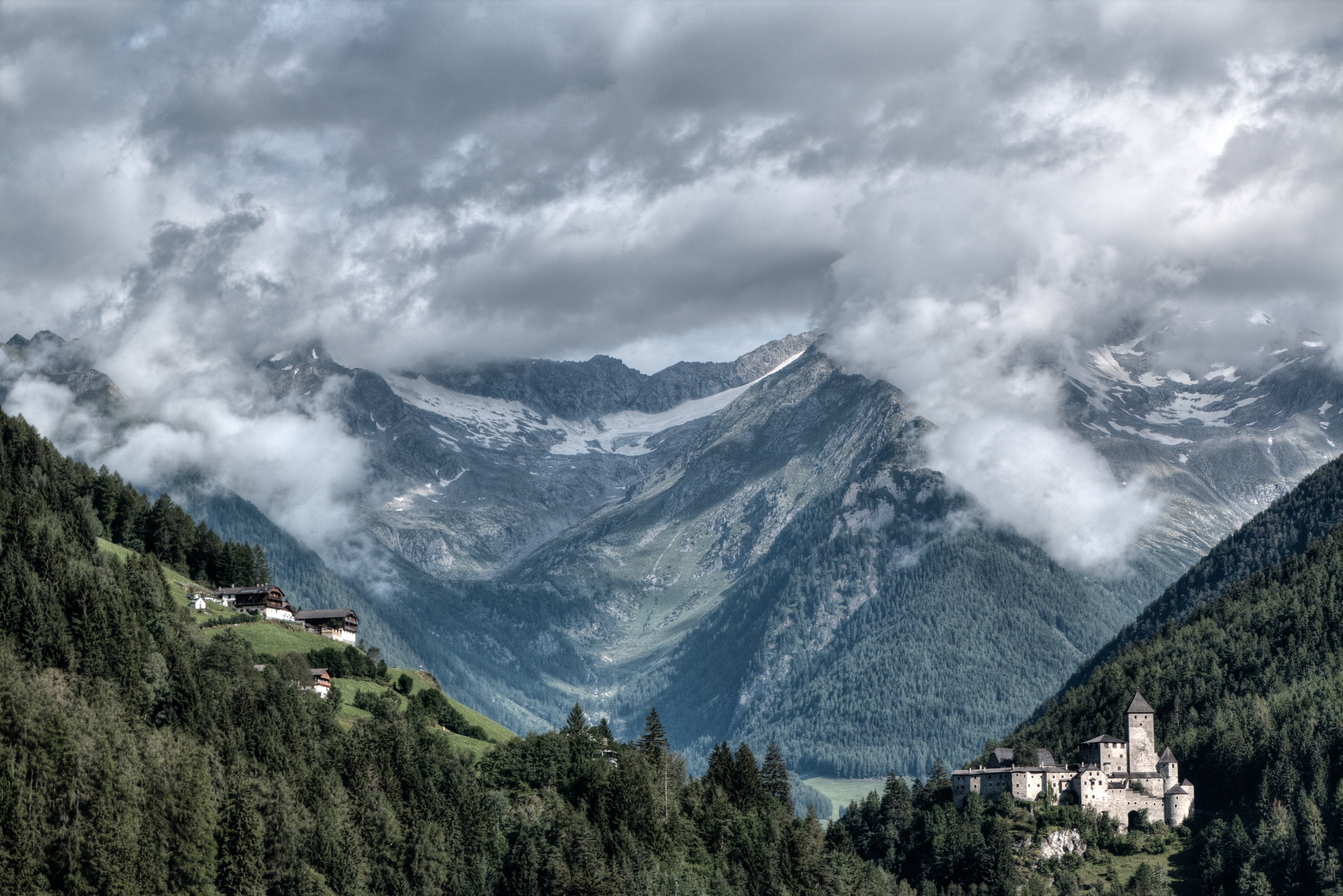 mountains, mountain, architecture, day, valley, tree, storm cloud, clouds, plant, environment, mountain range, outdoors, sky, forest, behind, storm, green, HD Wallpaper
