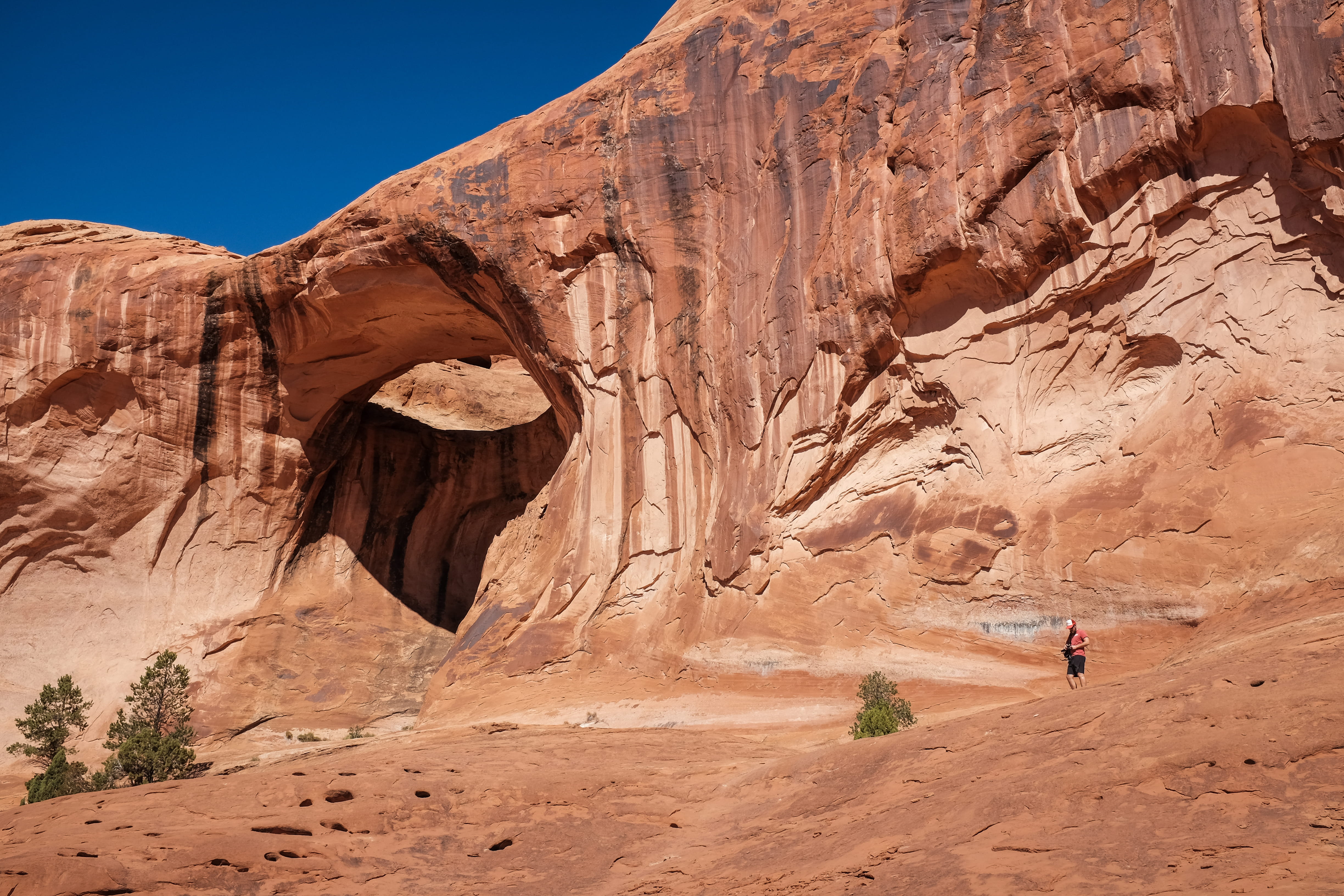 day, hole, man, eroded, nature, travel destinations, sandstone, landscape, explore, cave, outdoors, tranquility, land, rock, person, beauty in nature, mountain, HD Wallpaper