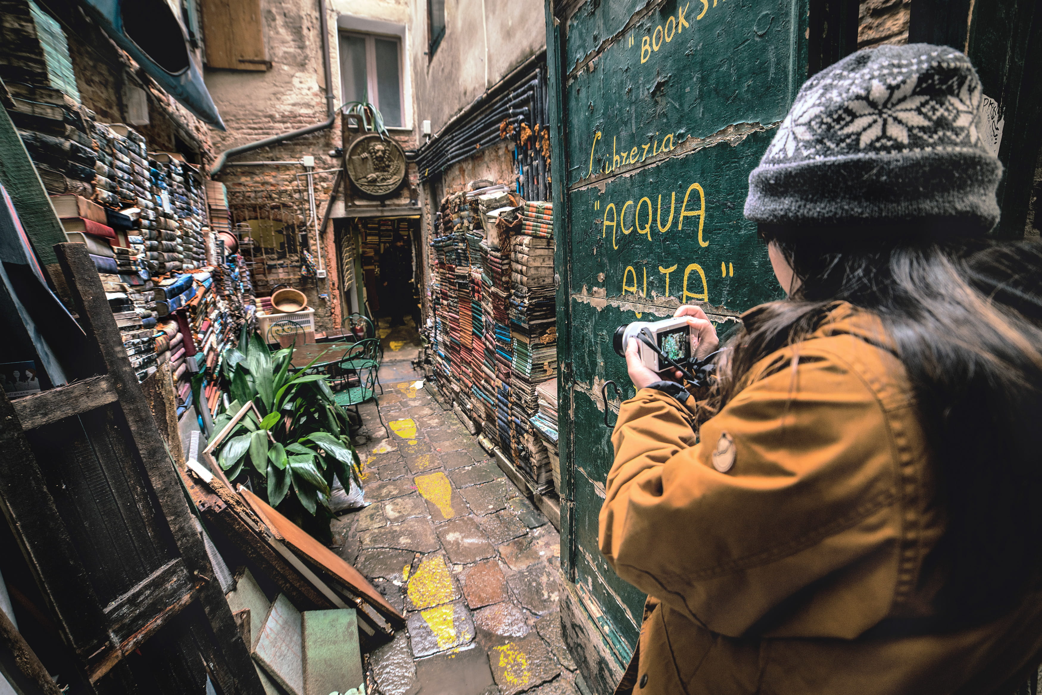 photo, built structure, waist up, hood - clothing, communication, urban, photographer, architecture, alley, day, 2K, women, building exterior, trip, lifestyles, HD Wallpaper