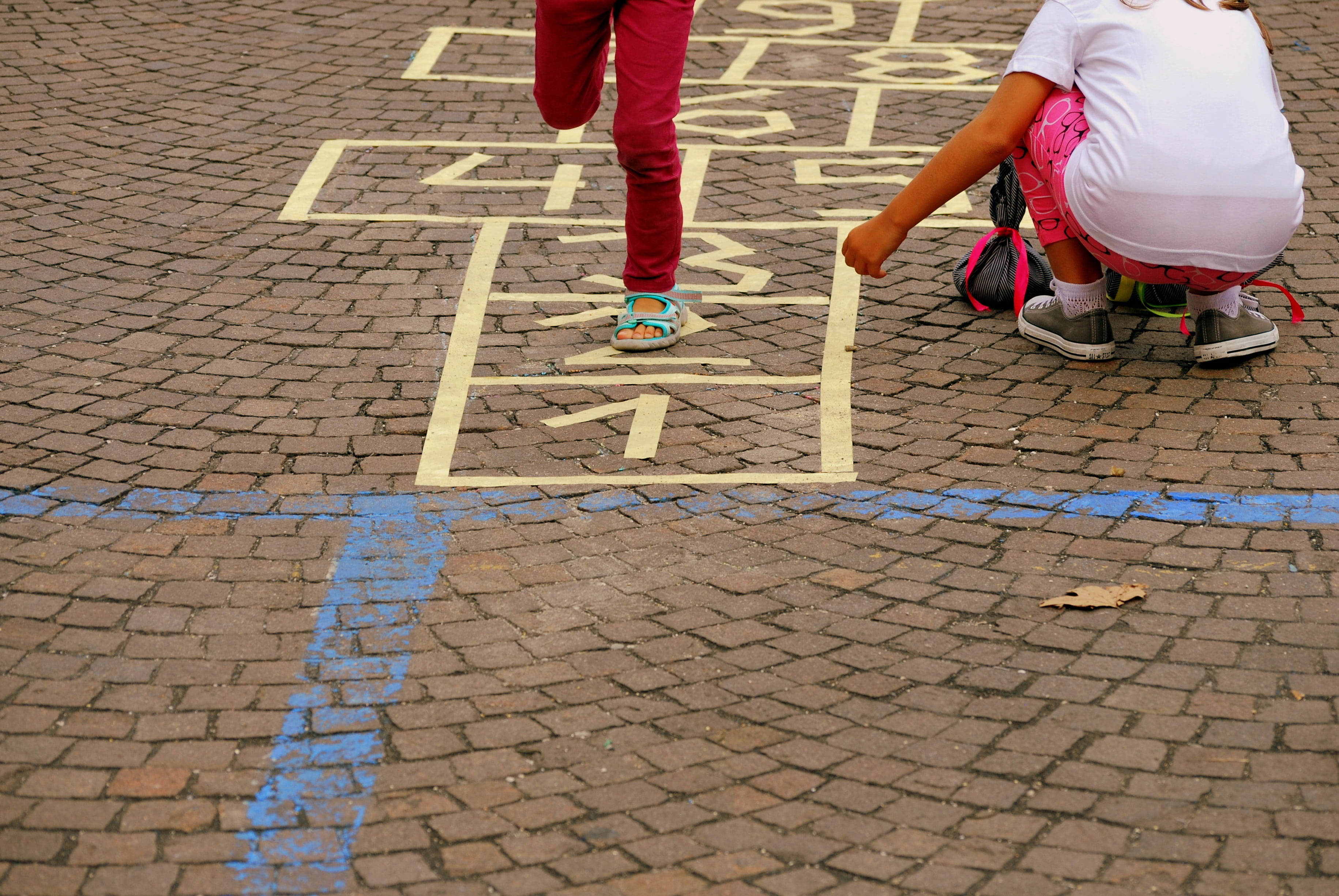 leisure activity, jump, city, low section, tocatì, road, street, people, two people, day, cobblestone, paving stone, outdoors, hopscotch, girls, women, HD Wallpaper