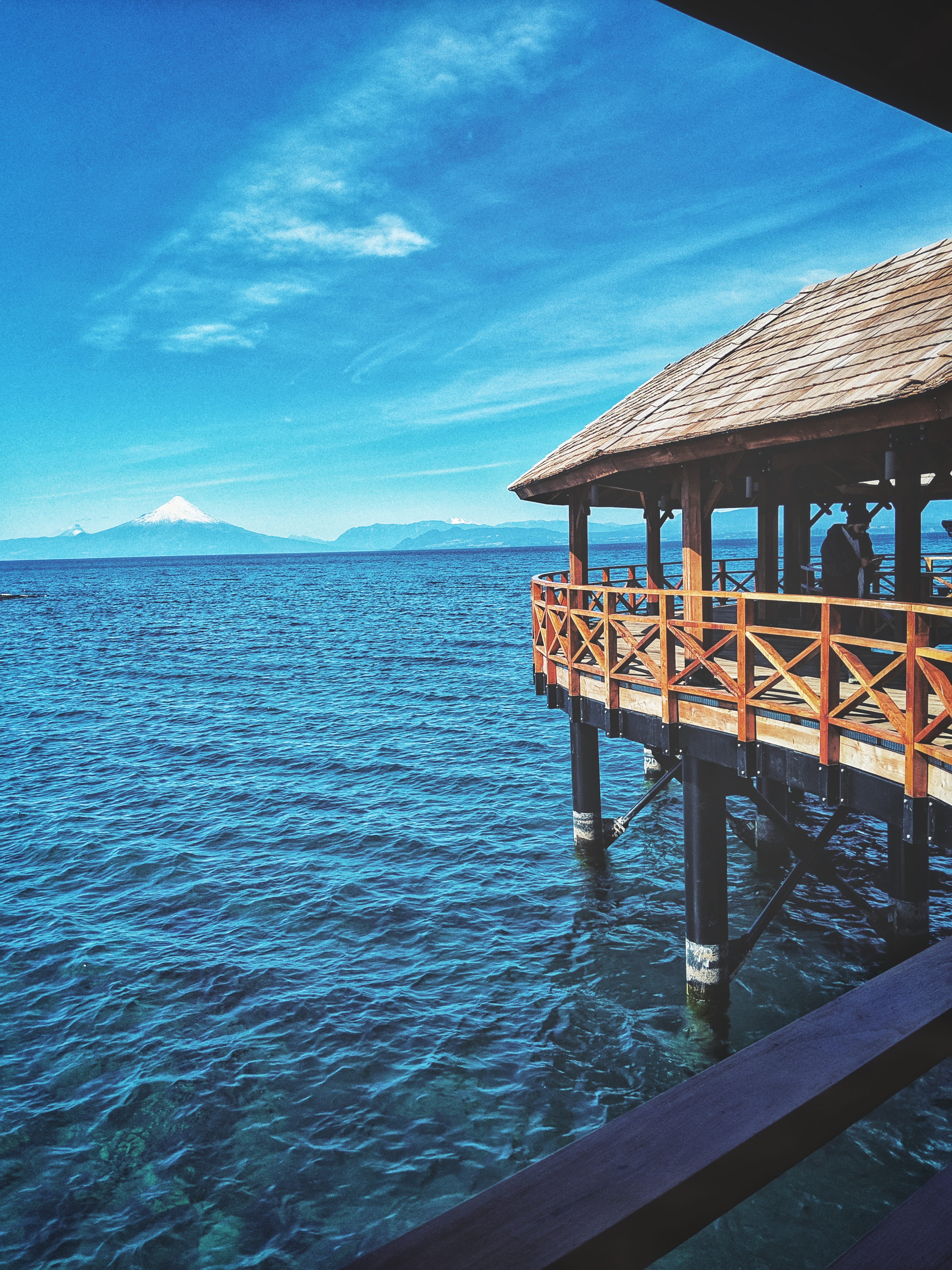 tranquility, human, lake, built structure, railing, no people, cloud - sky, tropical, beauty in nature, porch, building exterior, person, nature, 4K, wood - material, Phone HD Wallpaper