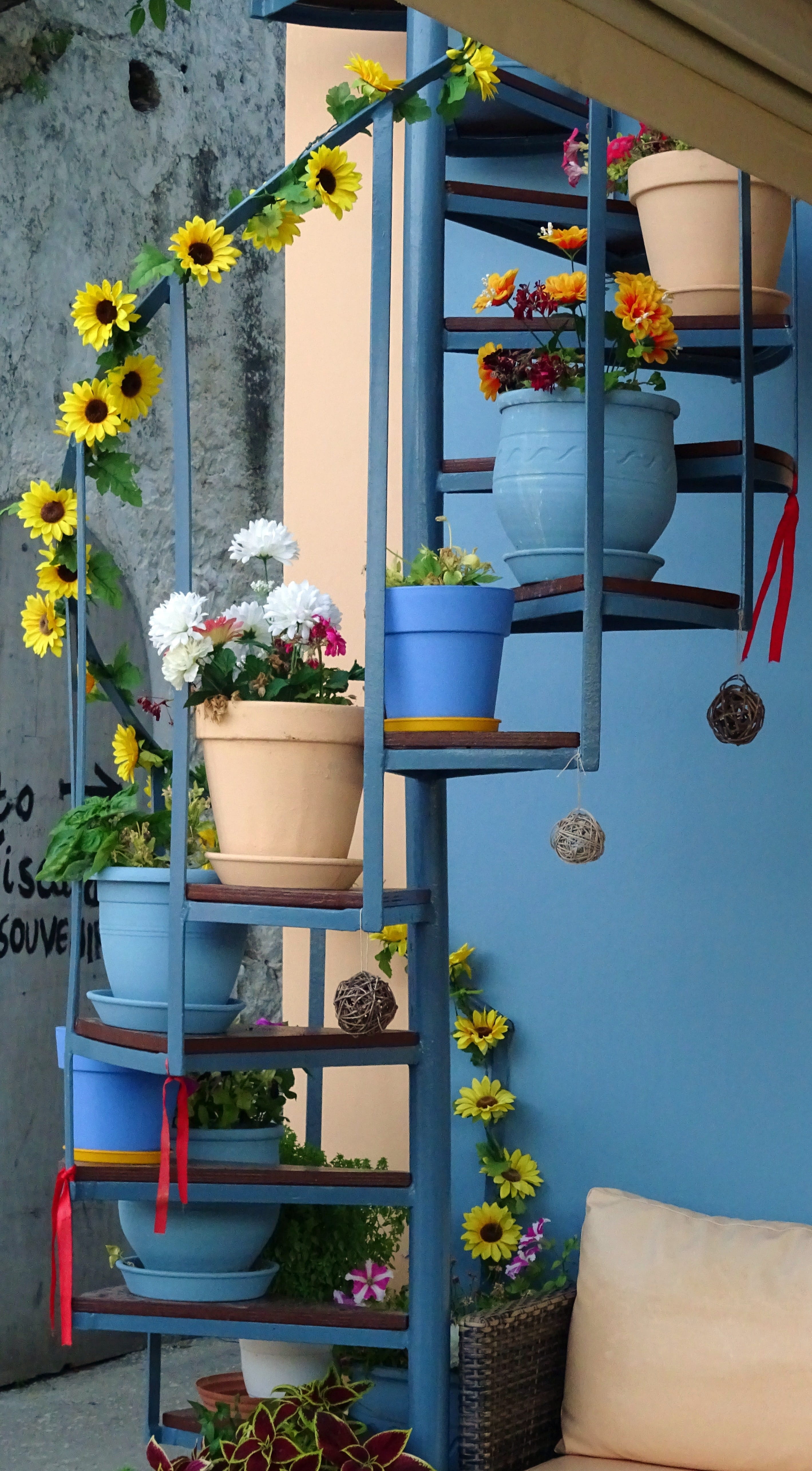 hanging, outdoors, yellow, sunflowers, greece, freshness, colors, fiscardo, flowerpots, spiral staircase, plant, vulnerability, flower, day, wall - building feature, Phone HD Wallpaper