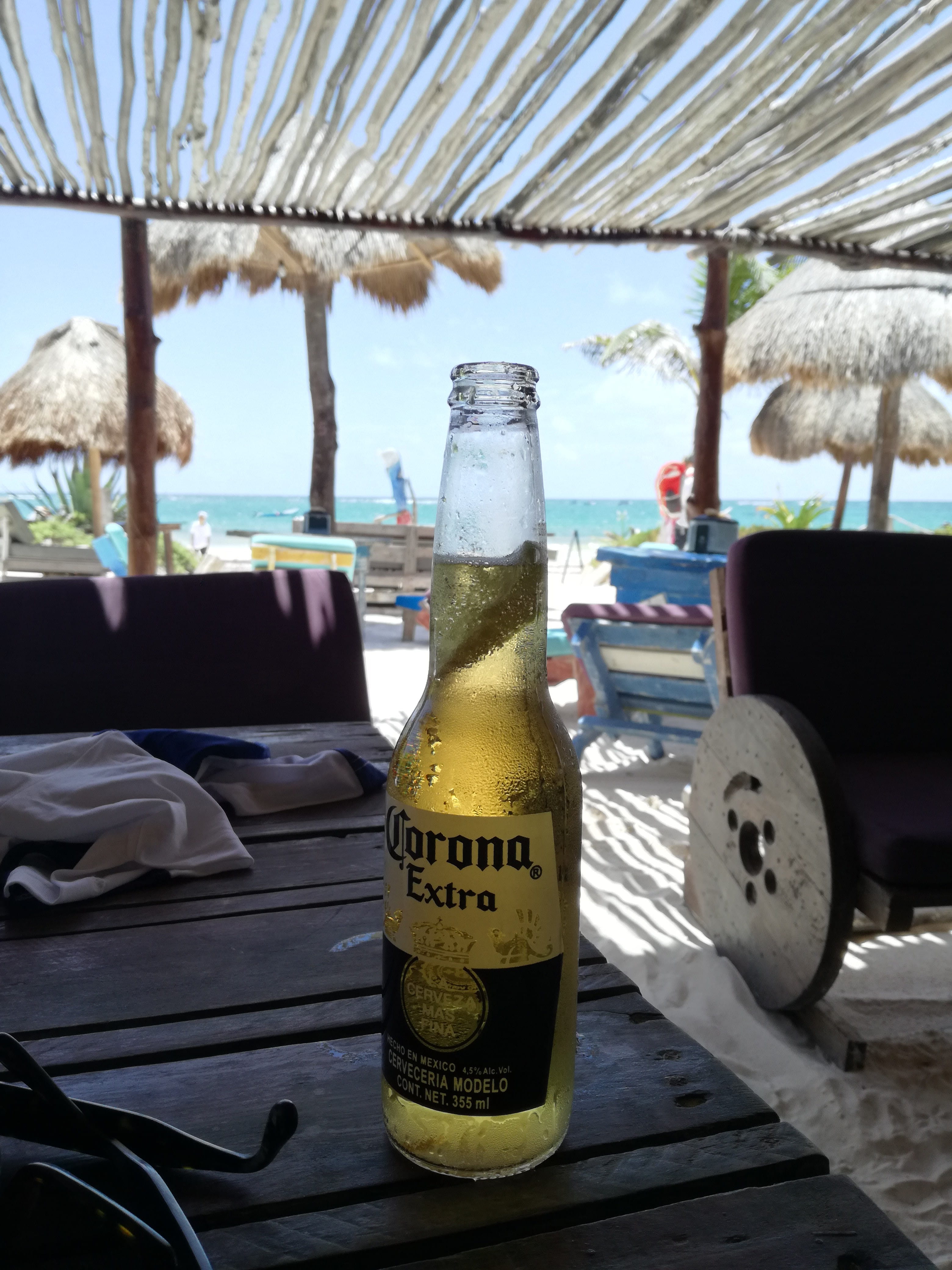 focus on foreground, alcohol, container, beer, fresh, bottle, food and drink, plage, mexico, 4K, close-up, bar, drink, day, ice, sand, table, playa del carmen, Phone HD Wallpaper