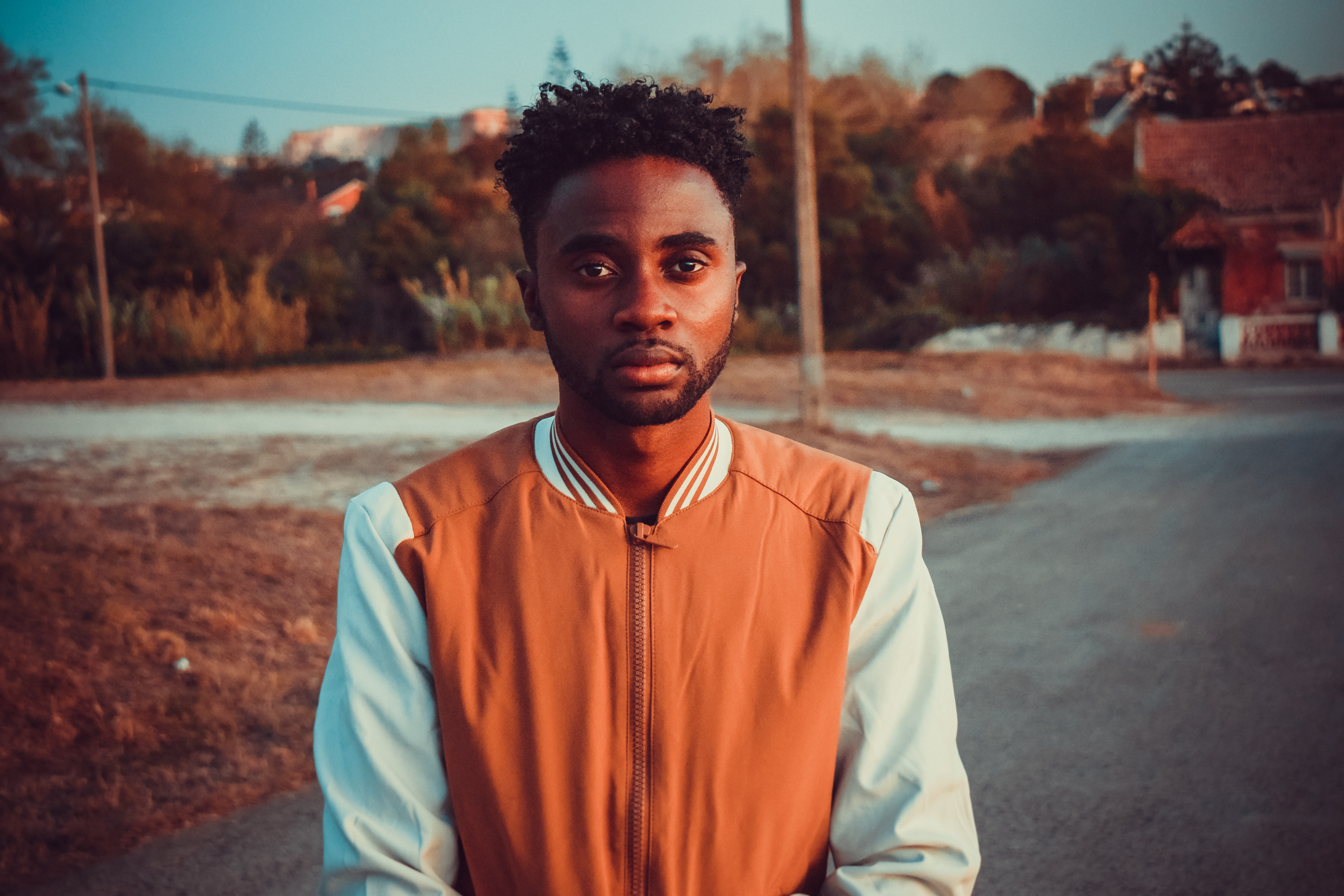 focus on foreground, one person, standing, young adult, road, portrait, leisure activity, African, nature, transportation, real people, front view, young men, HD Wallpaper