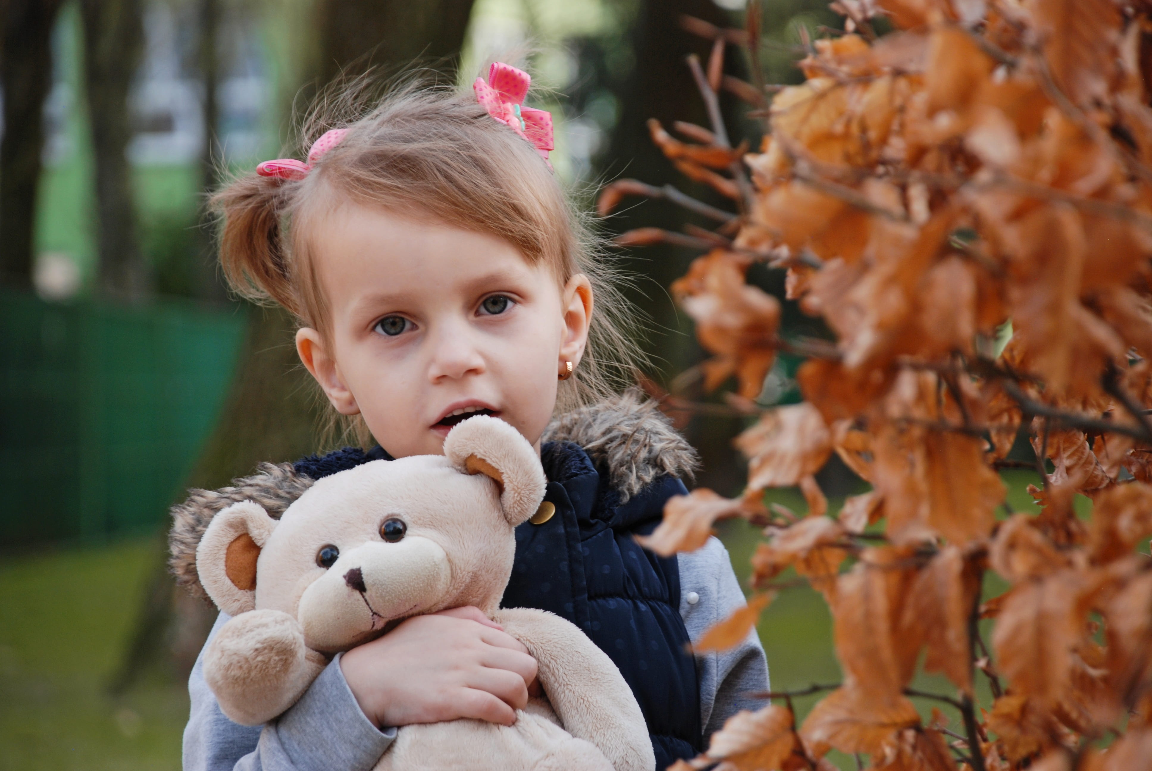 softness, toy, front view, women, little, joy, model, stuffed toy, outdoors, emotion, child, happiness, vacation, 4K, leaf, green, females, headshot, innocence, HD Wallpaper