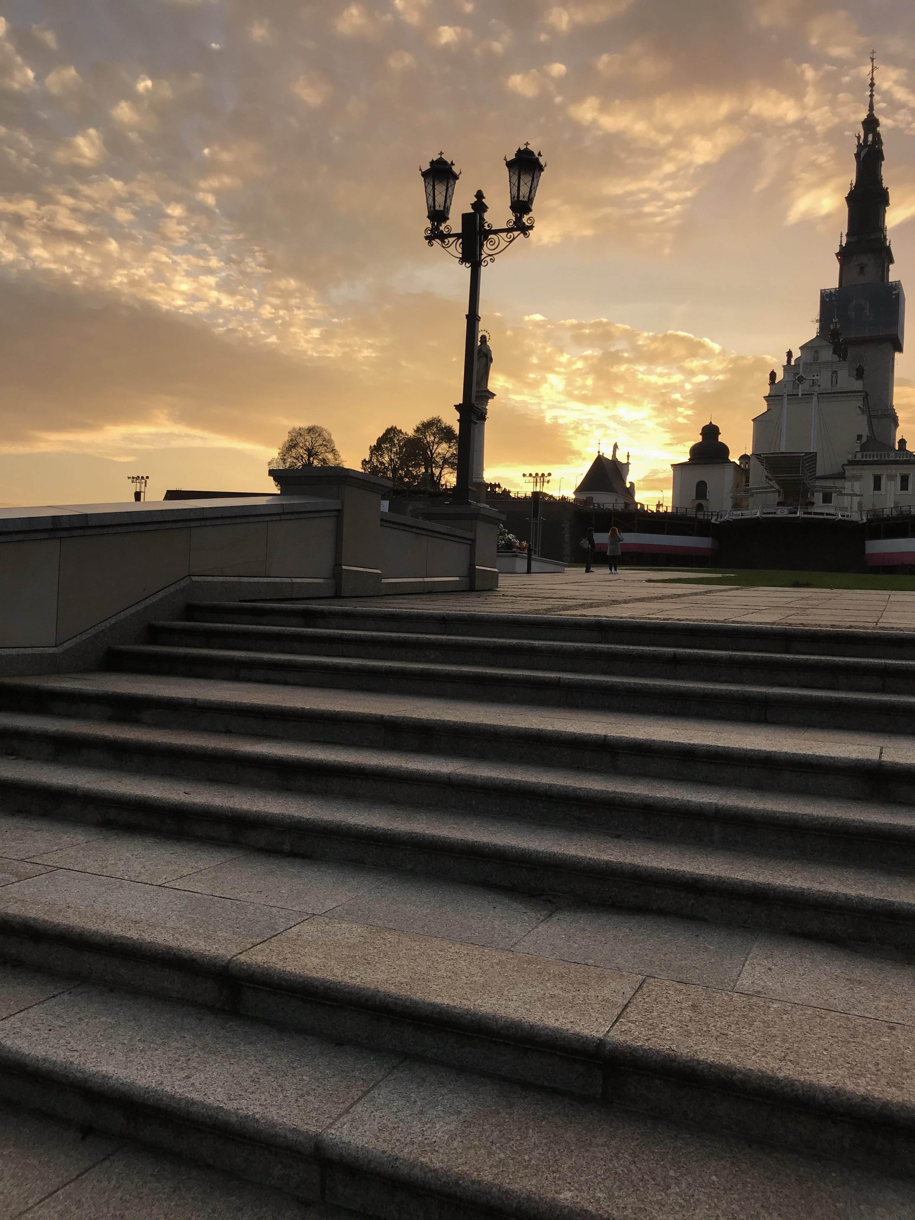 spirituality, cloud - sky, religion, orange color, staircase, building, alley, stroll, architecture, czestochowa, autumn, outdoors, city, cross, street light, Phone HD Wallpaper