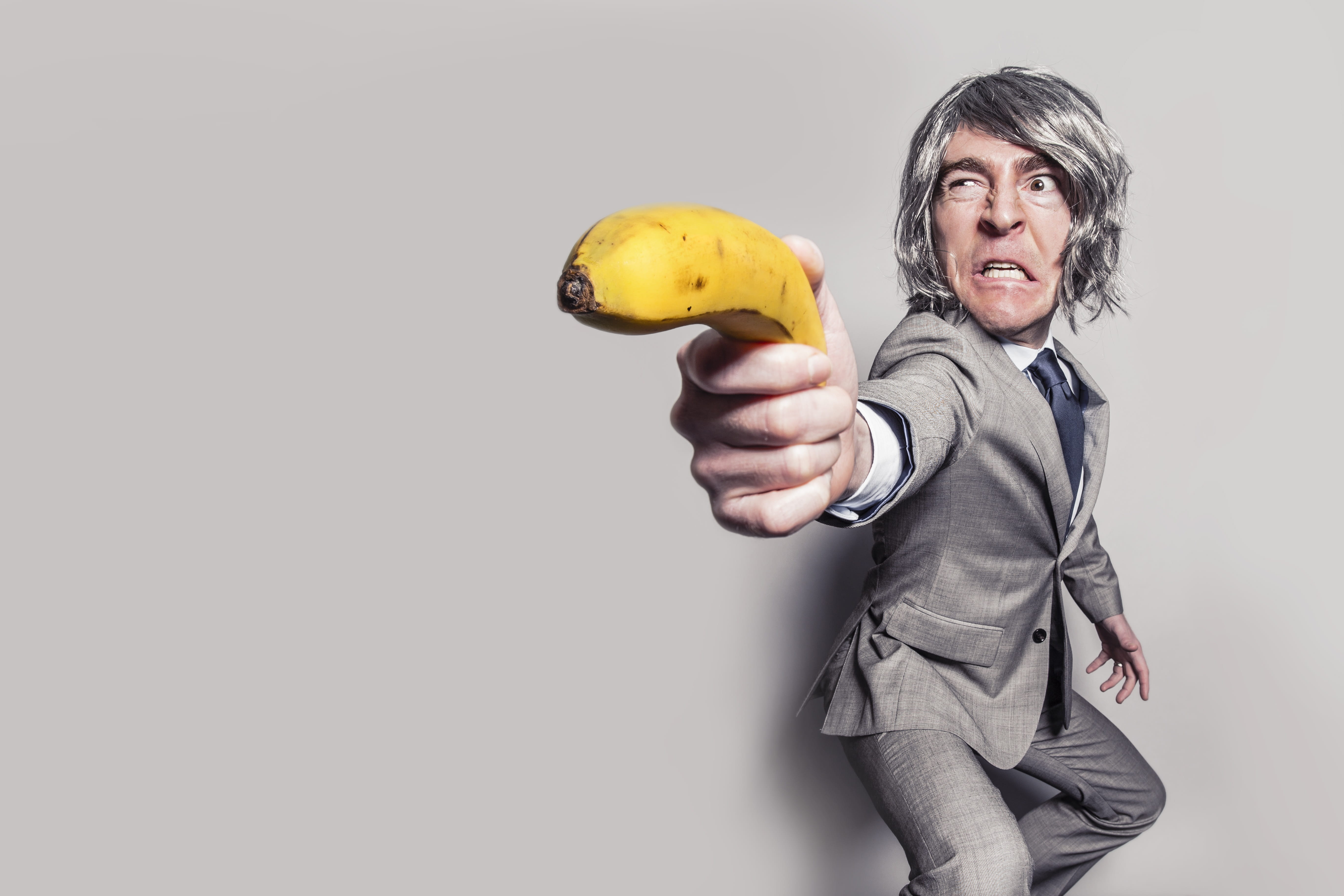 formal, standing, funny, banana, gray background, fun, hands, looking at camera, senior adult, studio shot, action, eyes, angry, suit, man, mature adult, HD Wallpaper