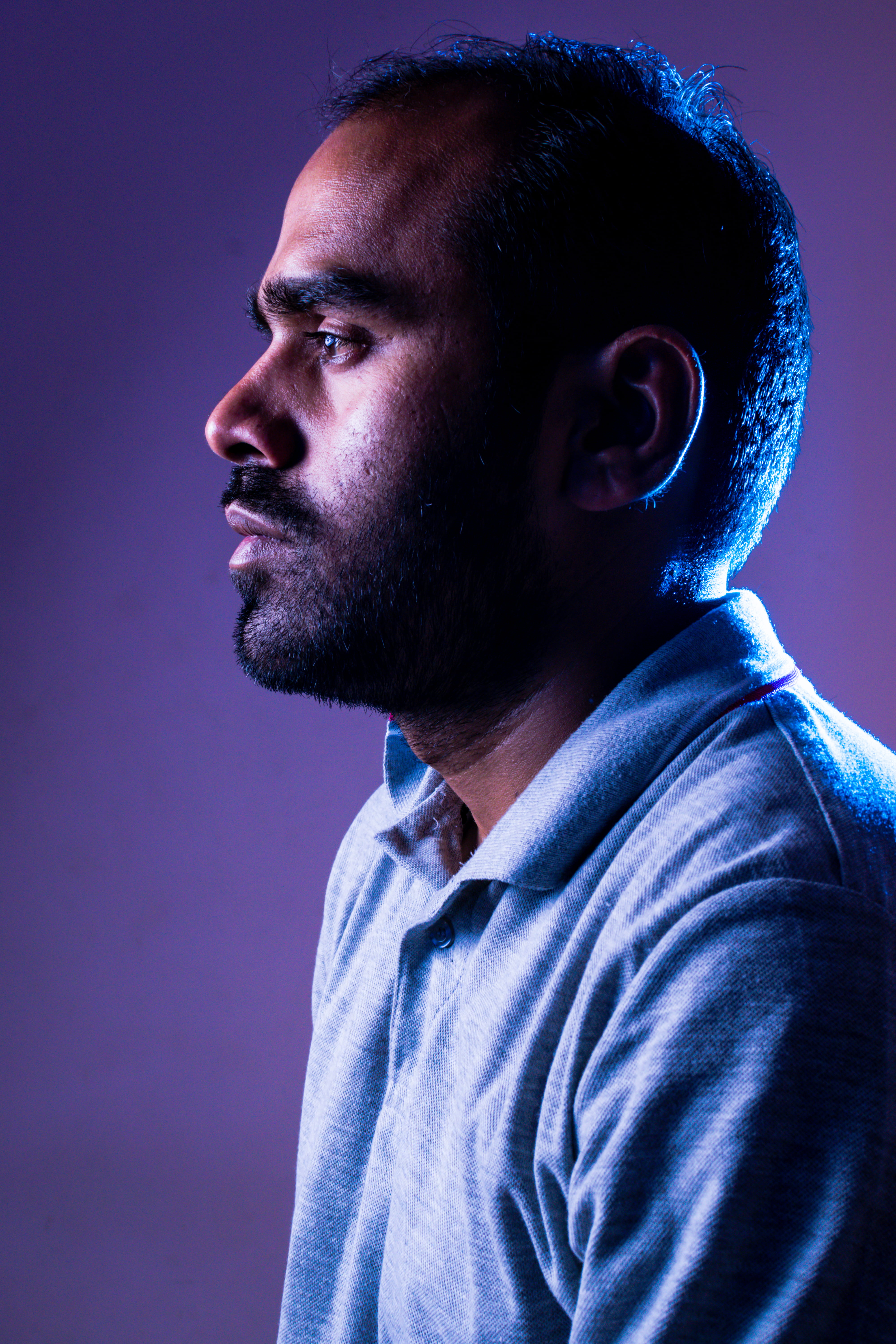 facing, lowkey, blue, 5K, looking away, facial hair, serious, male, depression - sadness, purple neon light, portrait, man, headshot, beard, adult, studio shot, Phone HD Wallpaper