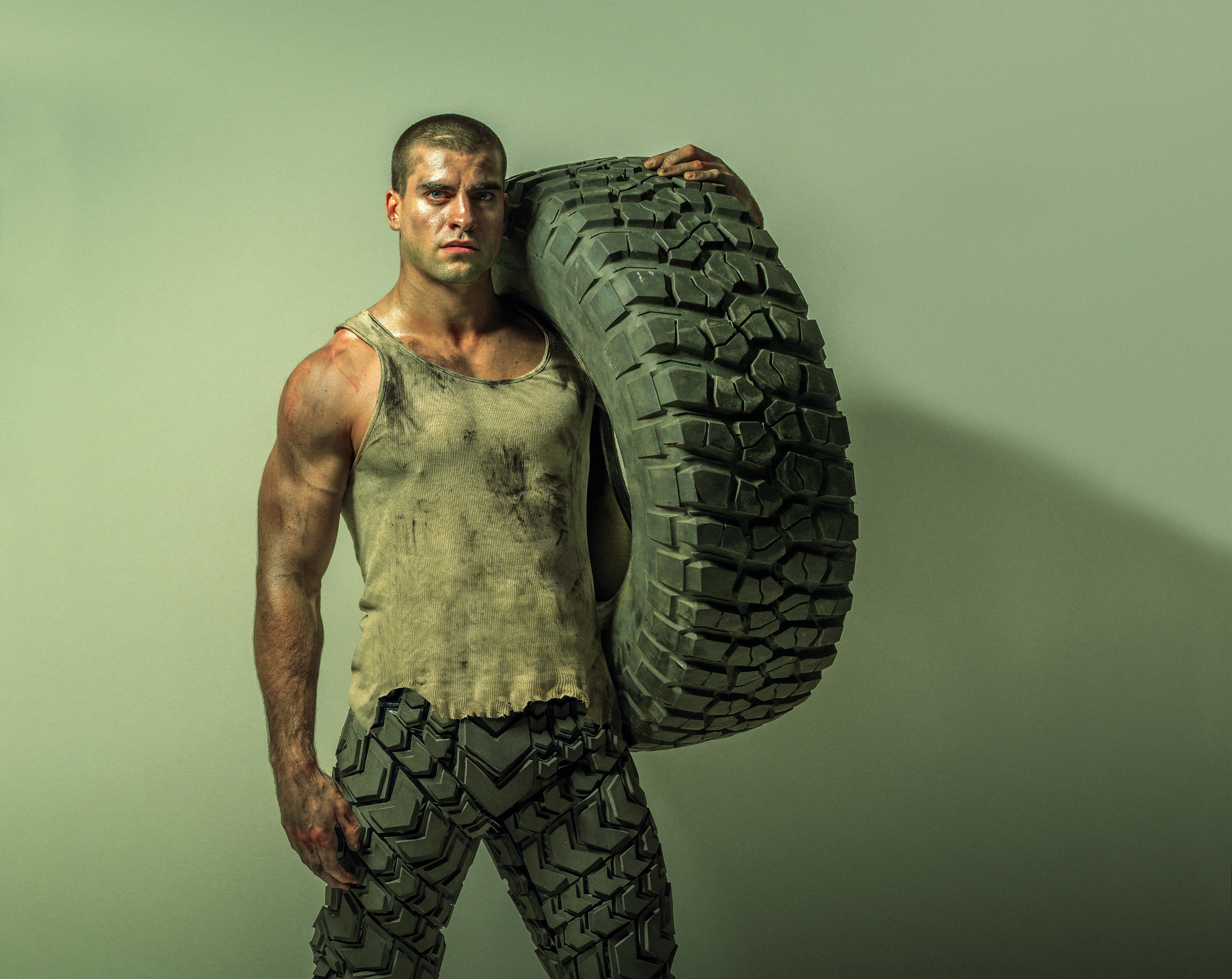 mockingjay, studio shot, 2014, Movies, indoors, tire, one person, Other Movies, shaved head, colored background, standing, games, 5K, adult, shirtless, HD Wallpaper