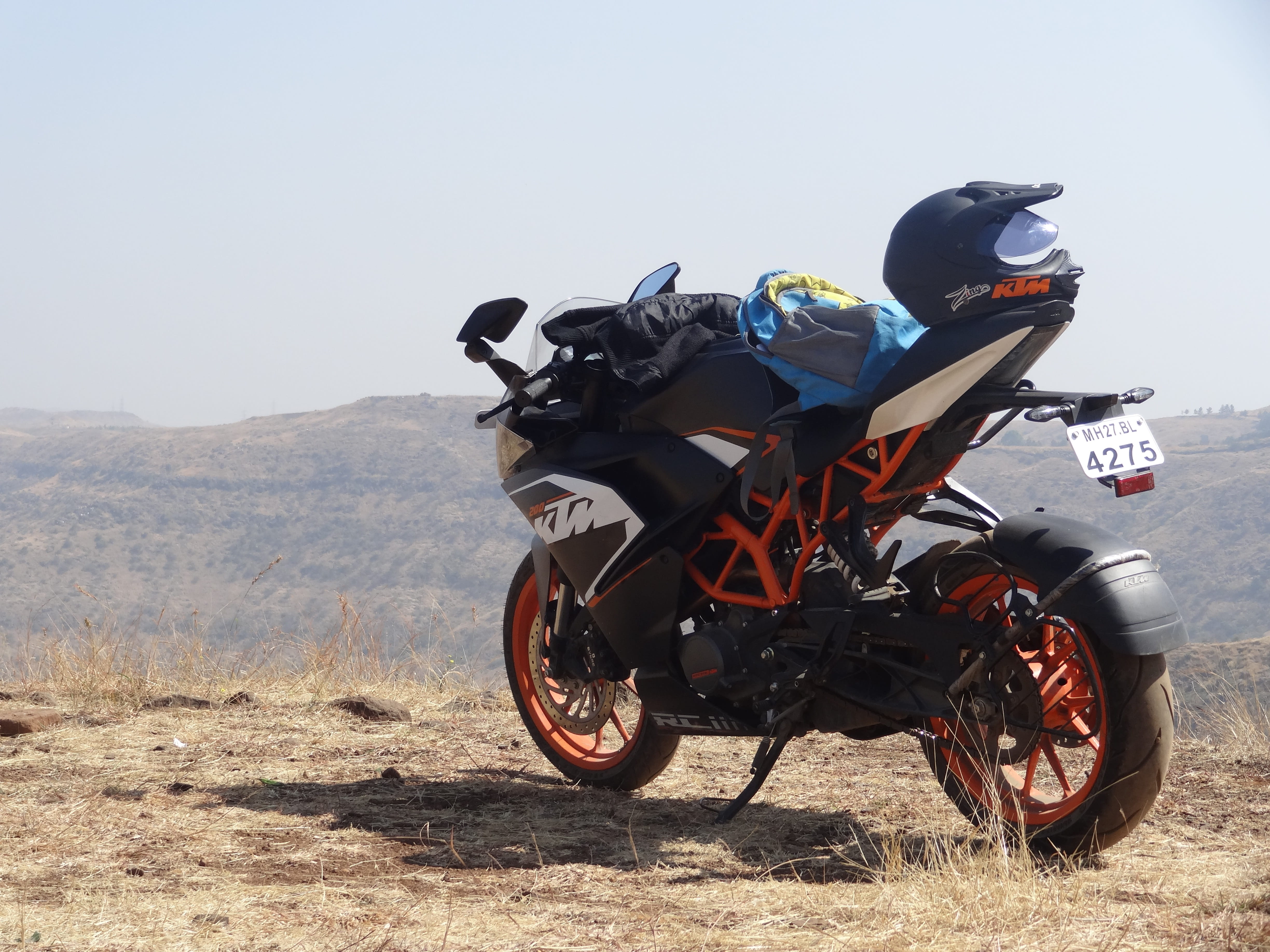 stationary, mountain, helmet, bike, clear sky, land, crash helmet, biker, land vehicle, riding, sunlight, environment, outdoors, nature, landscape, motorcycle, HD Wallpaper