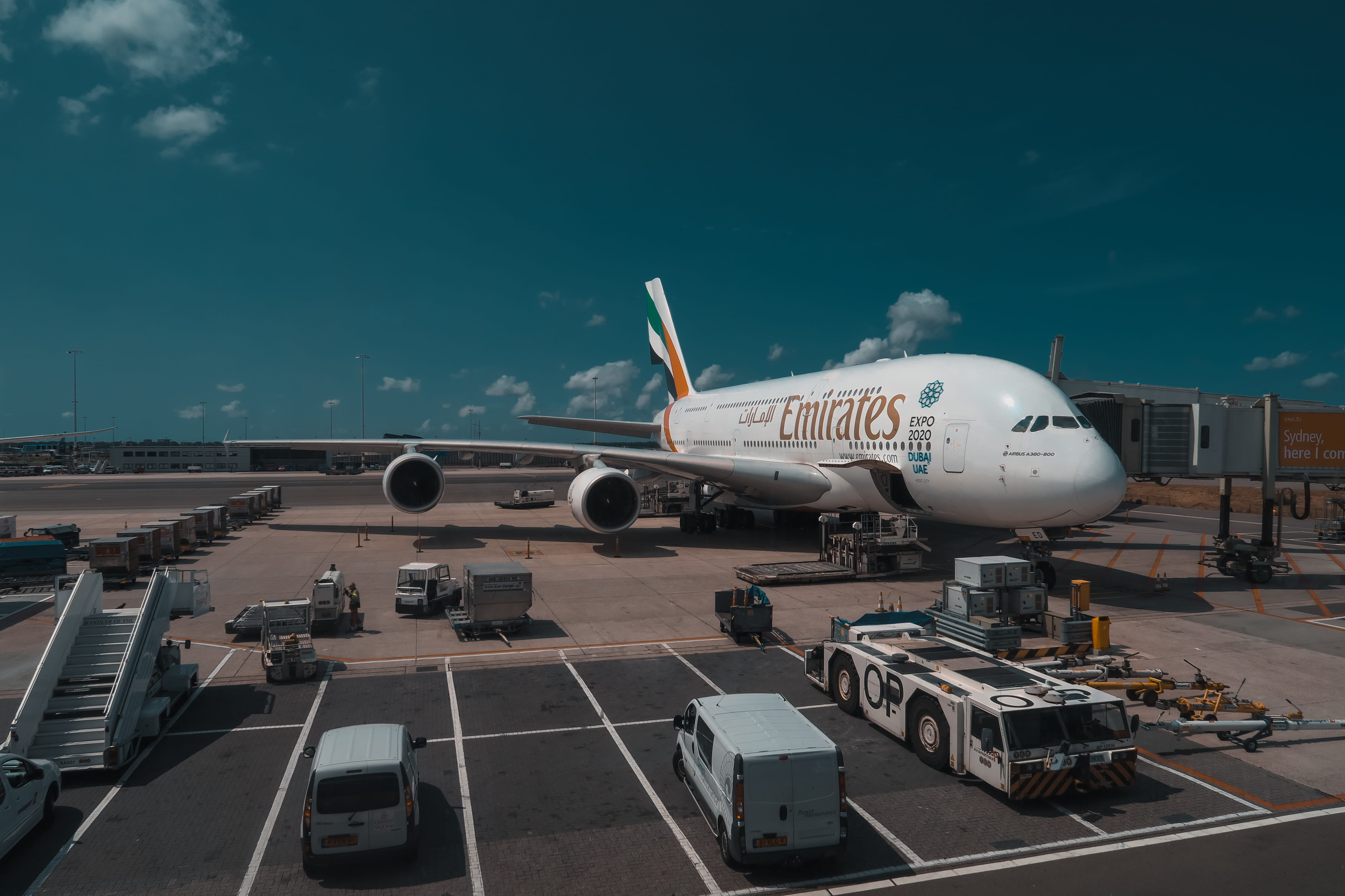 airplane, transportation, airport, day, sunlight, airport runway, road, outdoors, 5K, travel, nature, emirates, plane, white, land vehicle, passenger boarding bridge, HD Wallpaper