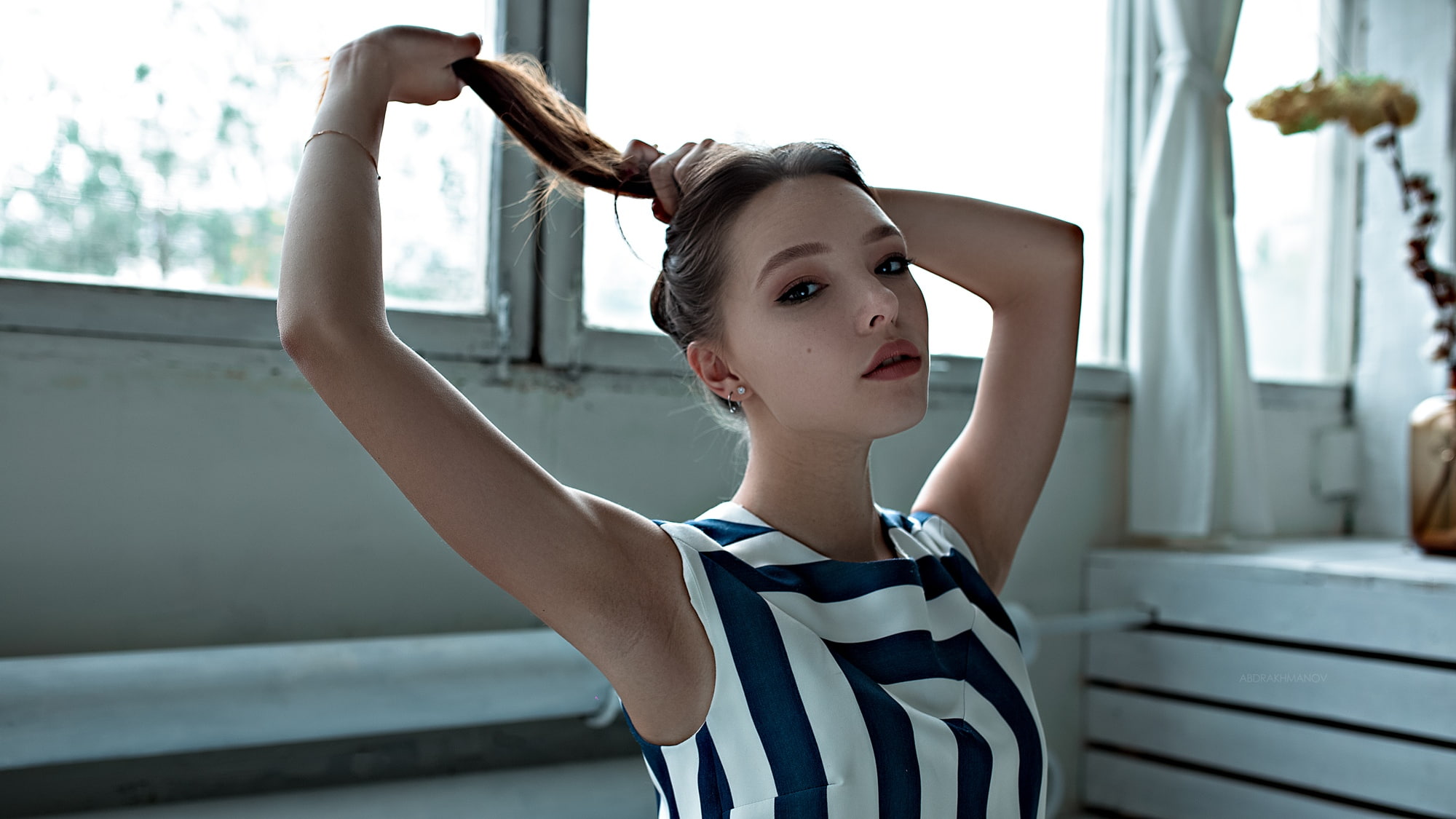 holding hair, women indoors, earring, window, model, bokeh, brunette, indoors, 1080P, Lenar Abdrakhmanov, portrait, face, looking at viewer, women, HD Wallpaper