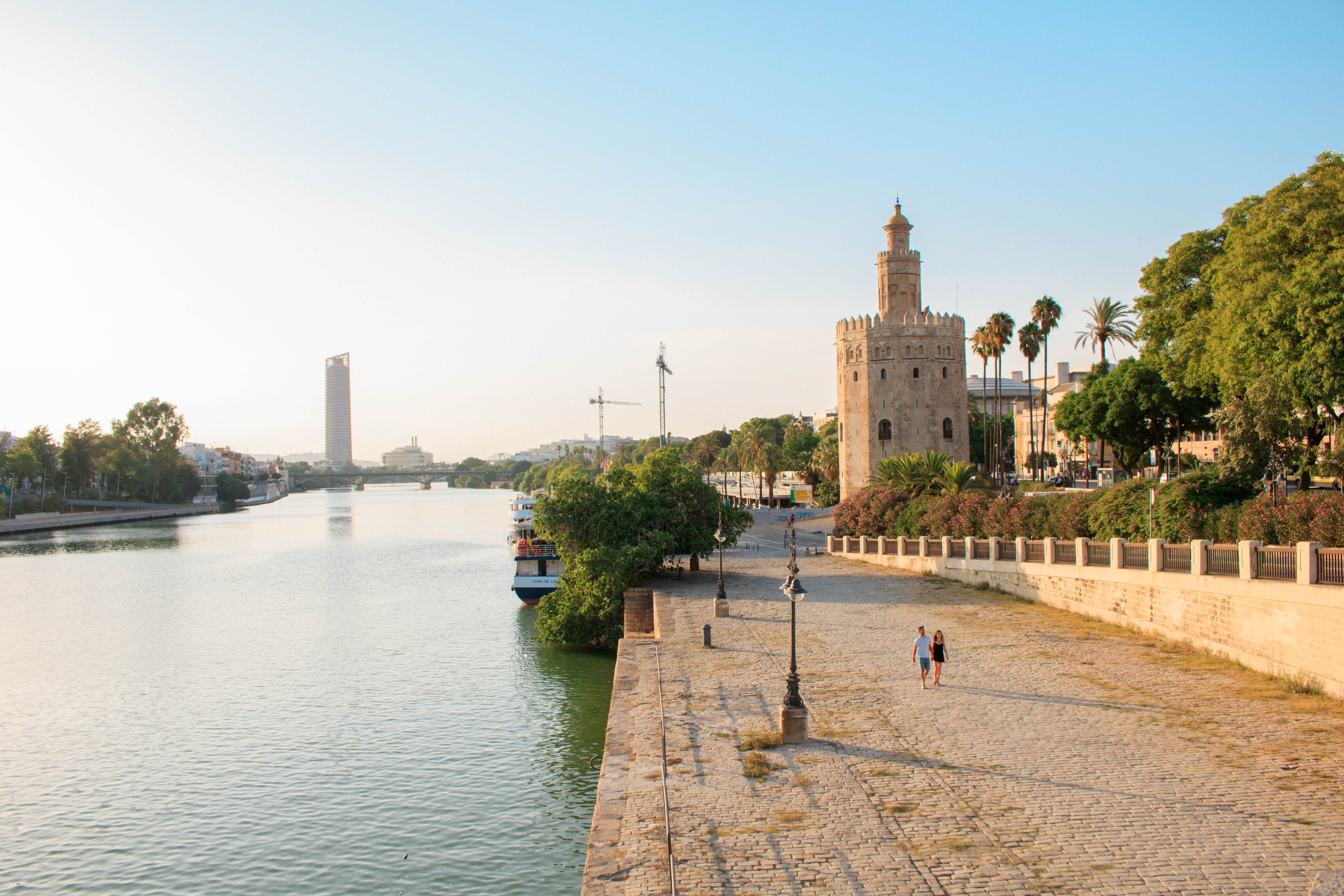 incidental people, plant, building exterior, españa, tree, outdoors, river, building, tower, water, travel destinations, architecture, couple, sevilla, HD Wallpaper