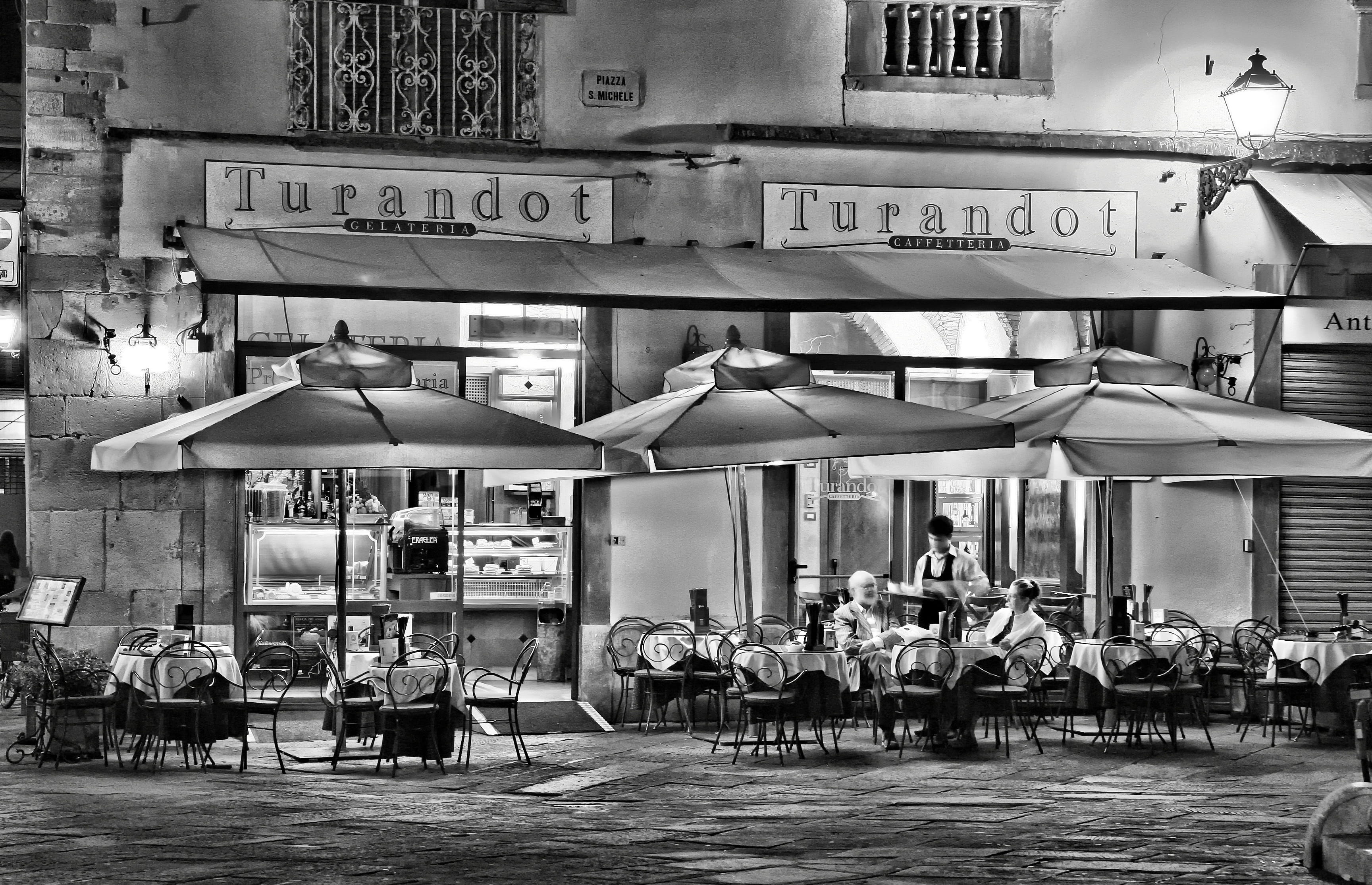 man, woman, built structure, city, setting, seat, business, real people, chairs, commerce, turandot, eating, work, vehicle, old town, 2K, black-and-white, HD Wallpaper