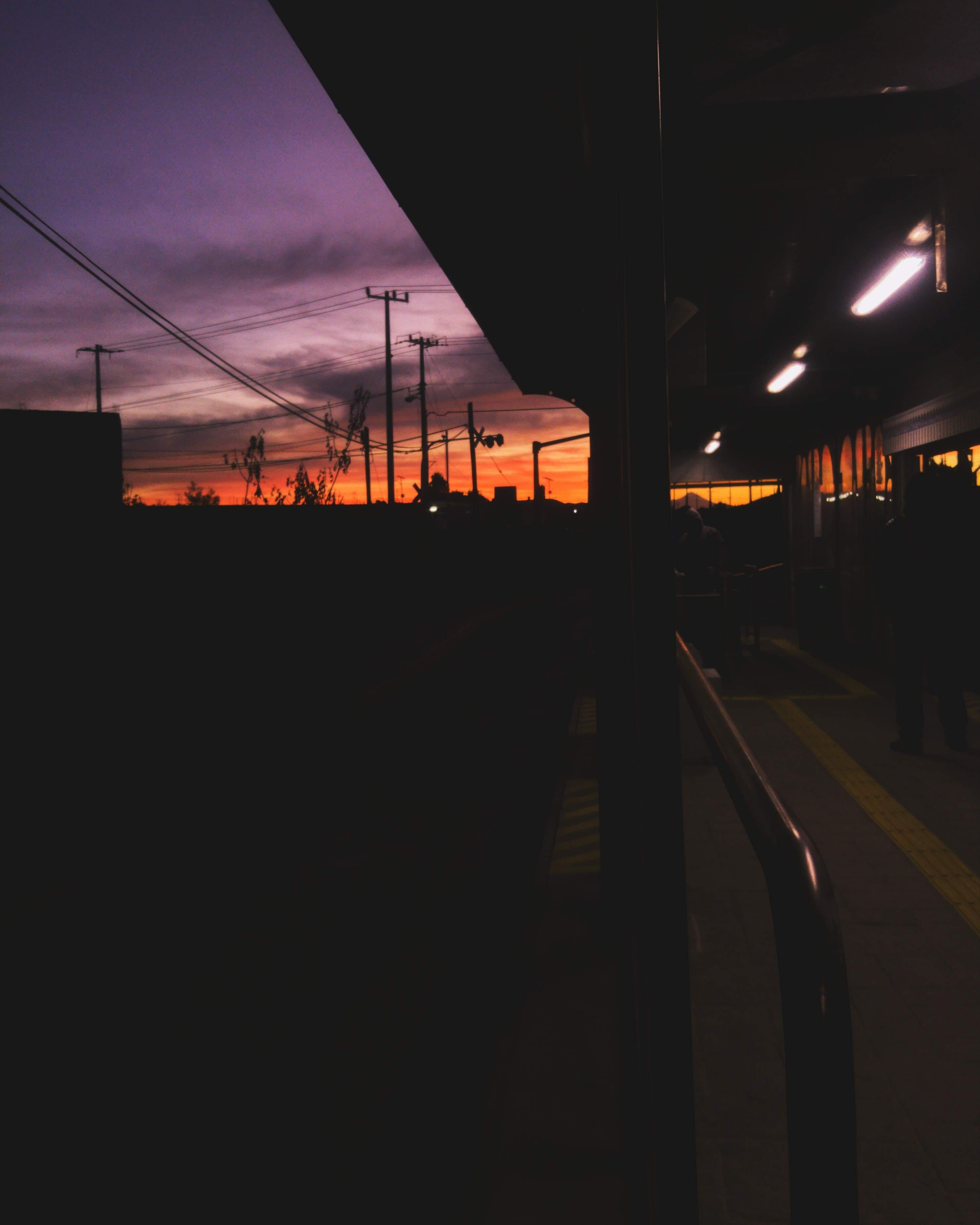 night, rail transportation, sunset, luces, silhouette, dawn, lighting equipment, track, bus stop, mode of transportation, outdoors, sky, architecture, power line, Phone HD Wallpaper