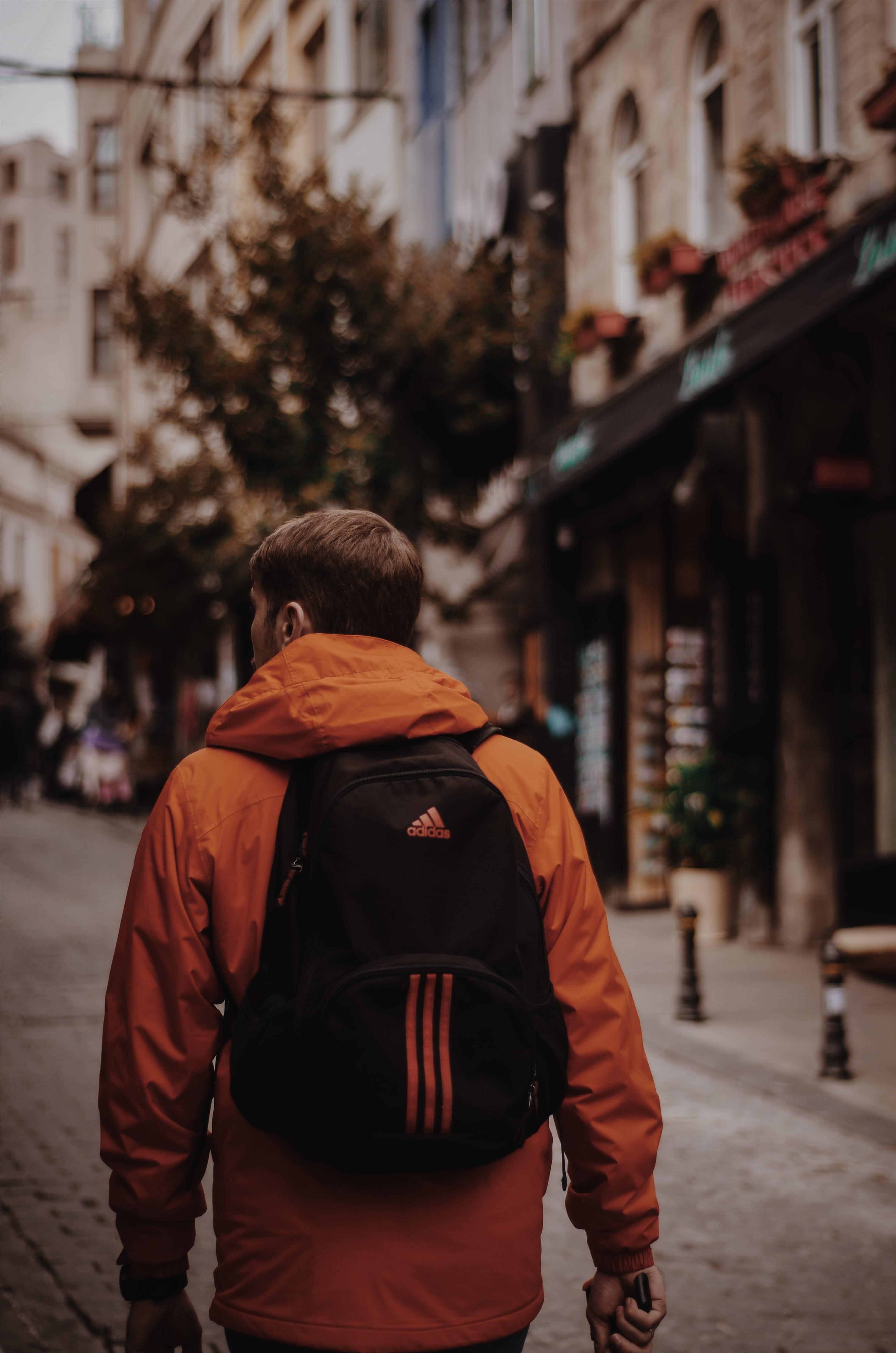 focus on foreground, town, daylight, architecture, building, 4K, city, backpack, leisure activity, adidas, fashion, lifestyles, city life, hoodie, walks, Phone HD Wallpaper