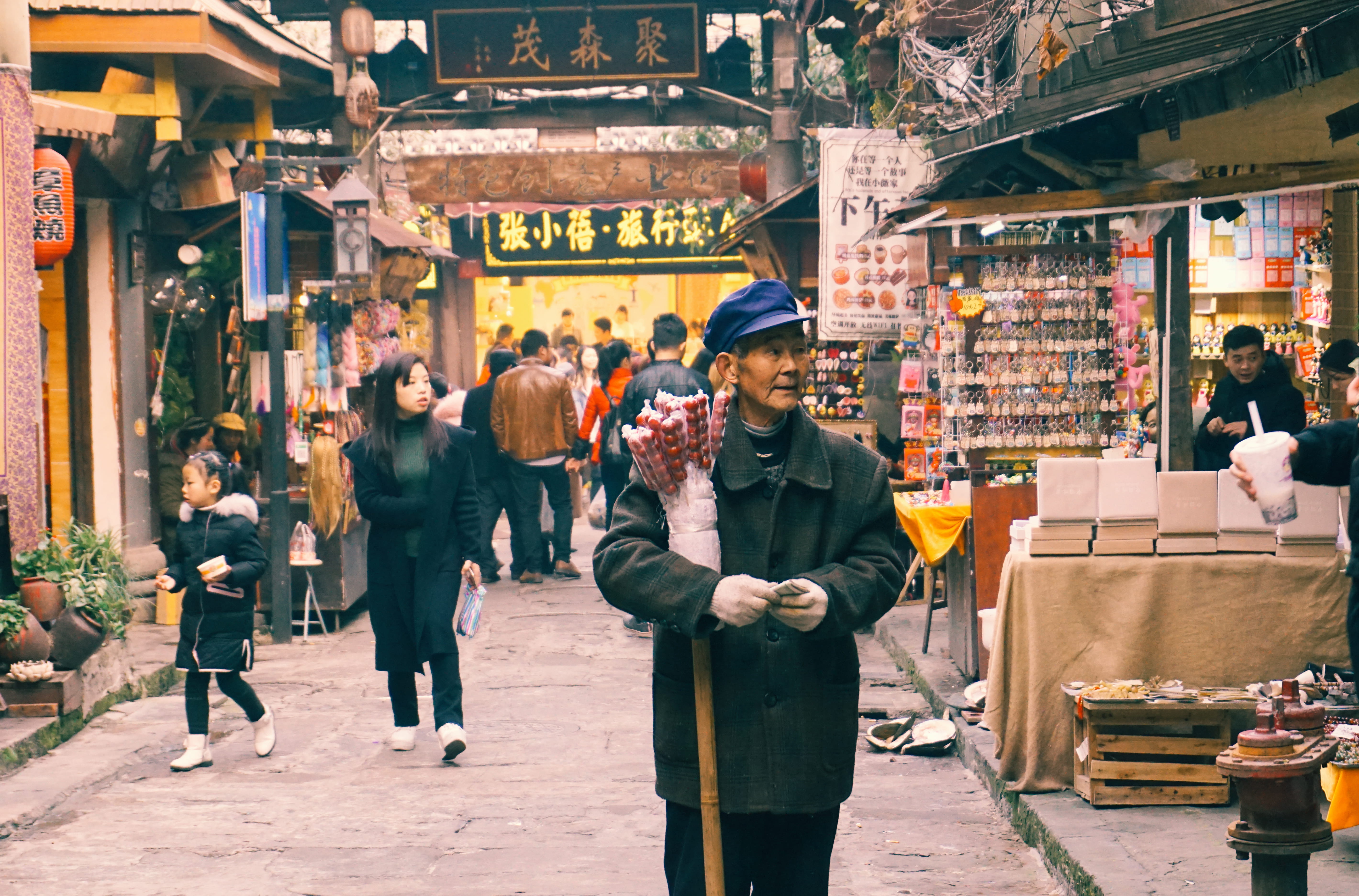 group of people, young men, outdoors, adult, crowd, stores, blue, walking, men, daylight, button, street, pavement, woman, road, warm clothing, hat, people, HD Wallpaper