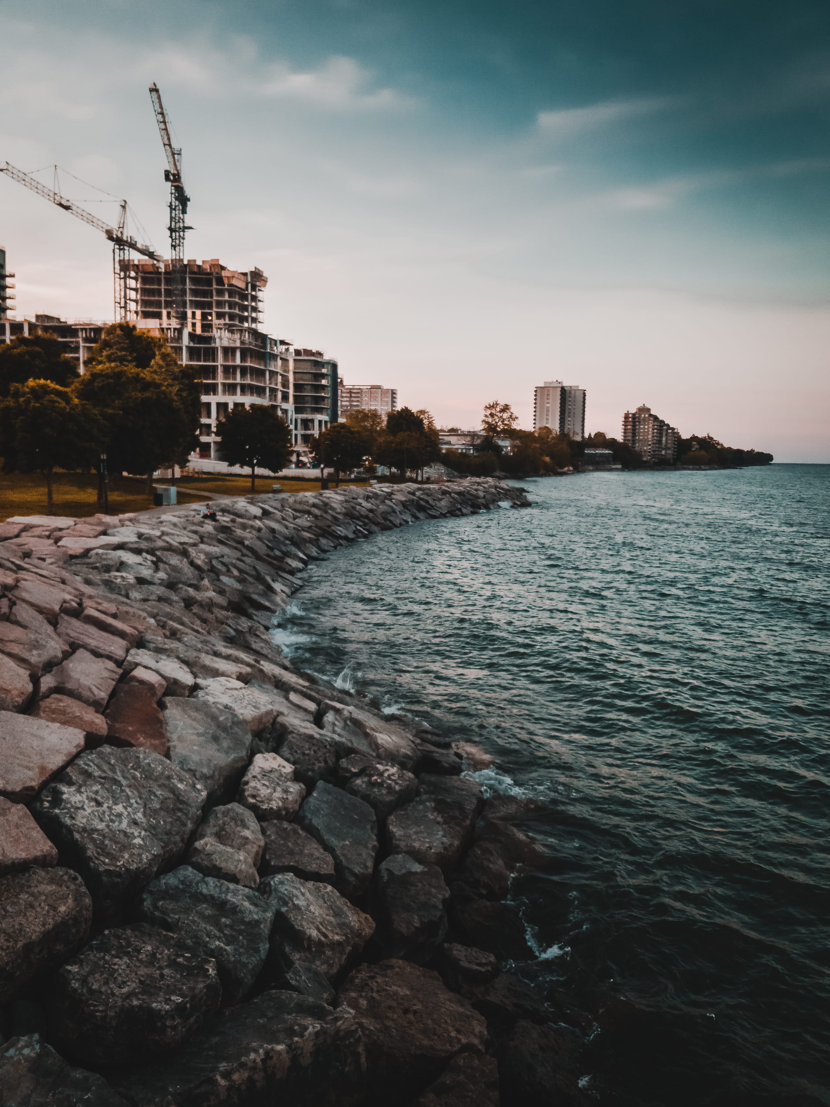 rock, water, sky, skyscraper, blue, ocean, burlington, canada, beach, cloud - sky, burlington beach, high rise, coast, tree, sea, architecture, city, land, Phone HD Wallpaper