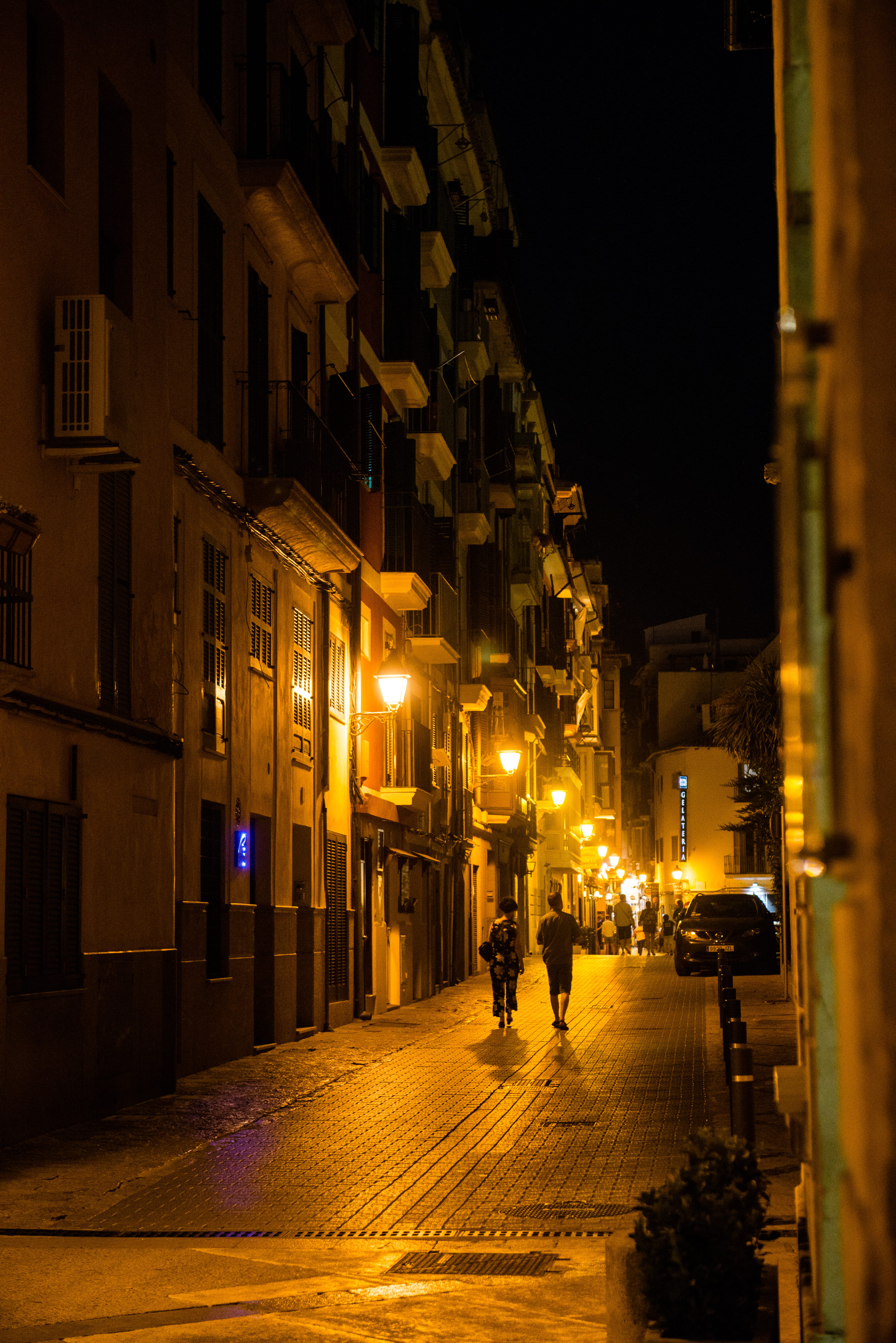 outdoors, direction, road, illuminated, building exterior, city, dark, houses, built structure, mode of transportation, real people, incidental people, Phone HD Wallpaper