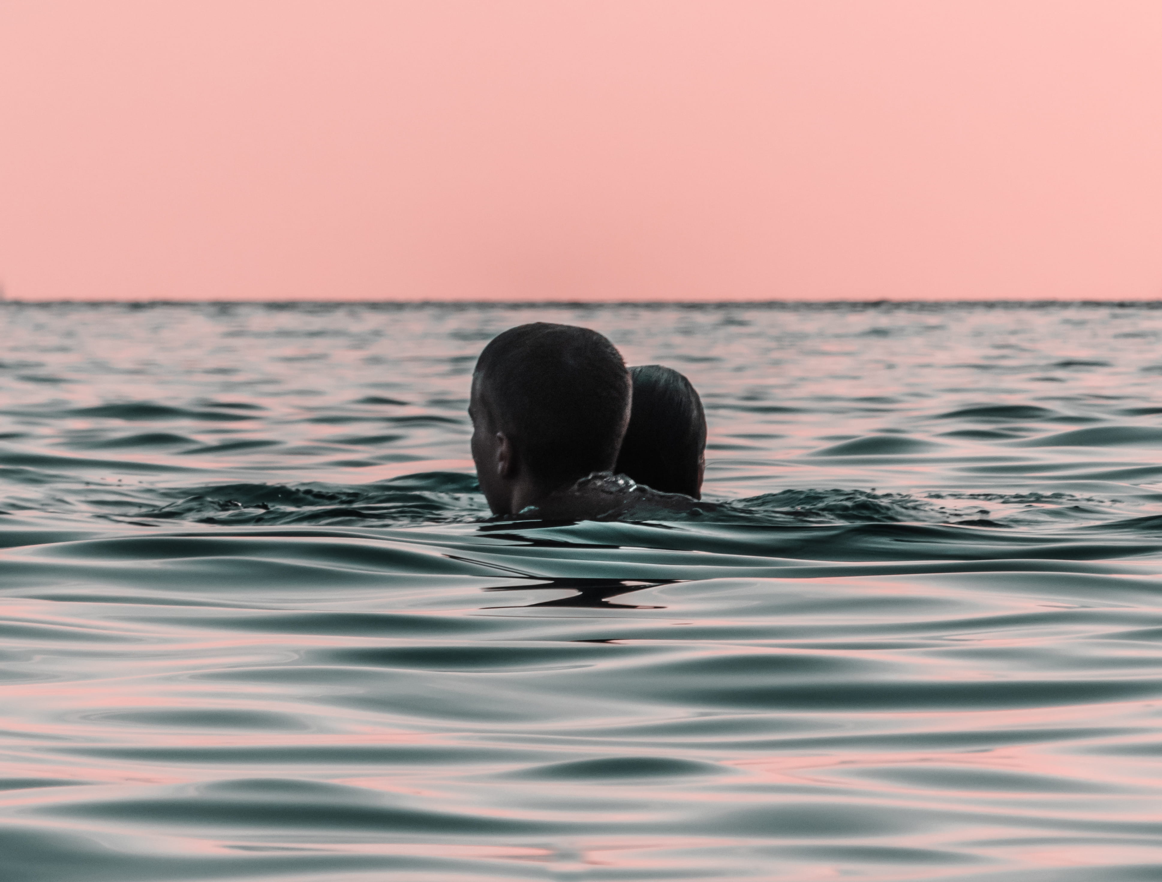 couple, rippled, marine, animals in the wild, sunset, man, swimming, woman, wave, head, water, animal themes, beauty in nature, sunrise, horizon, shore, HD Wallpaper
