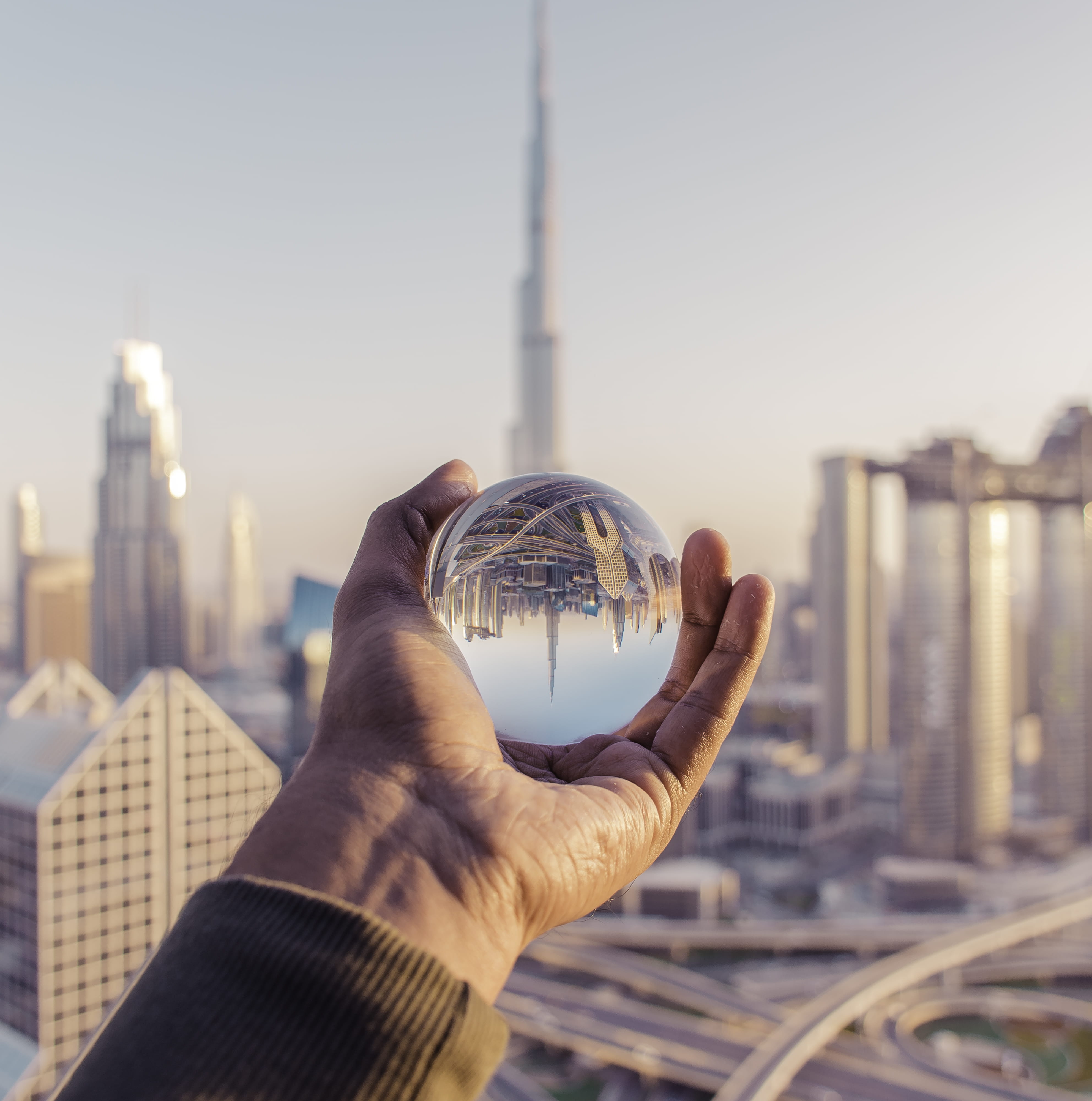sky, ball, holding, human body part, built structure, one person, 4K, glass ball, clear sky, city, personal perspective, outdoors, skyscraper, building exterior, Phone HD Wallpaper