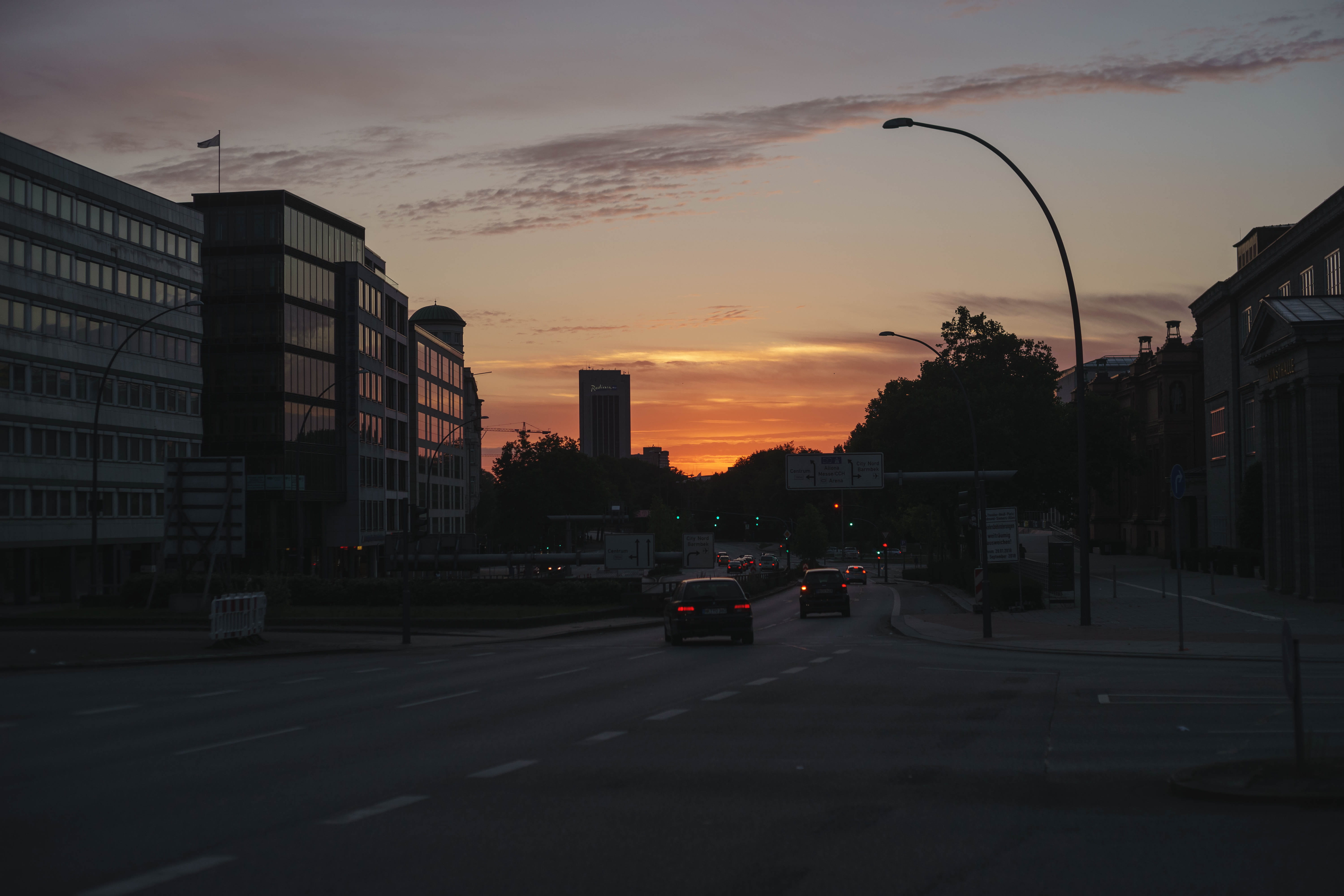 city street, transportation, land vehicle, travel, 5K, dark, motor vehicle, road, cloud - sky, orange color, building, building exterior, sunset, hamburg, HD Wallpaper